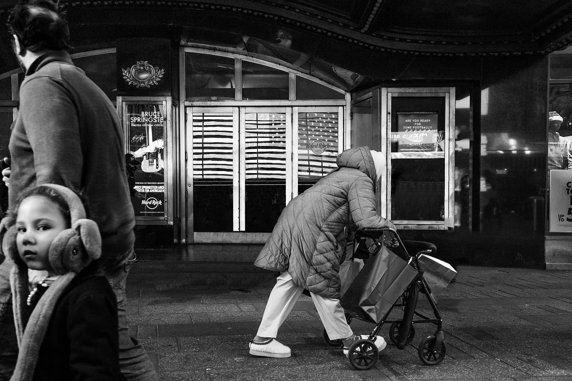 Homeless Lady pushing a cart in front of Hard Rock Cafe, New York City, USA