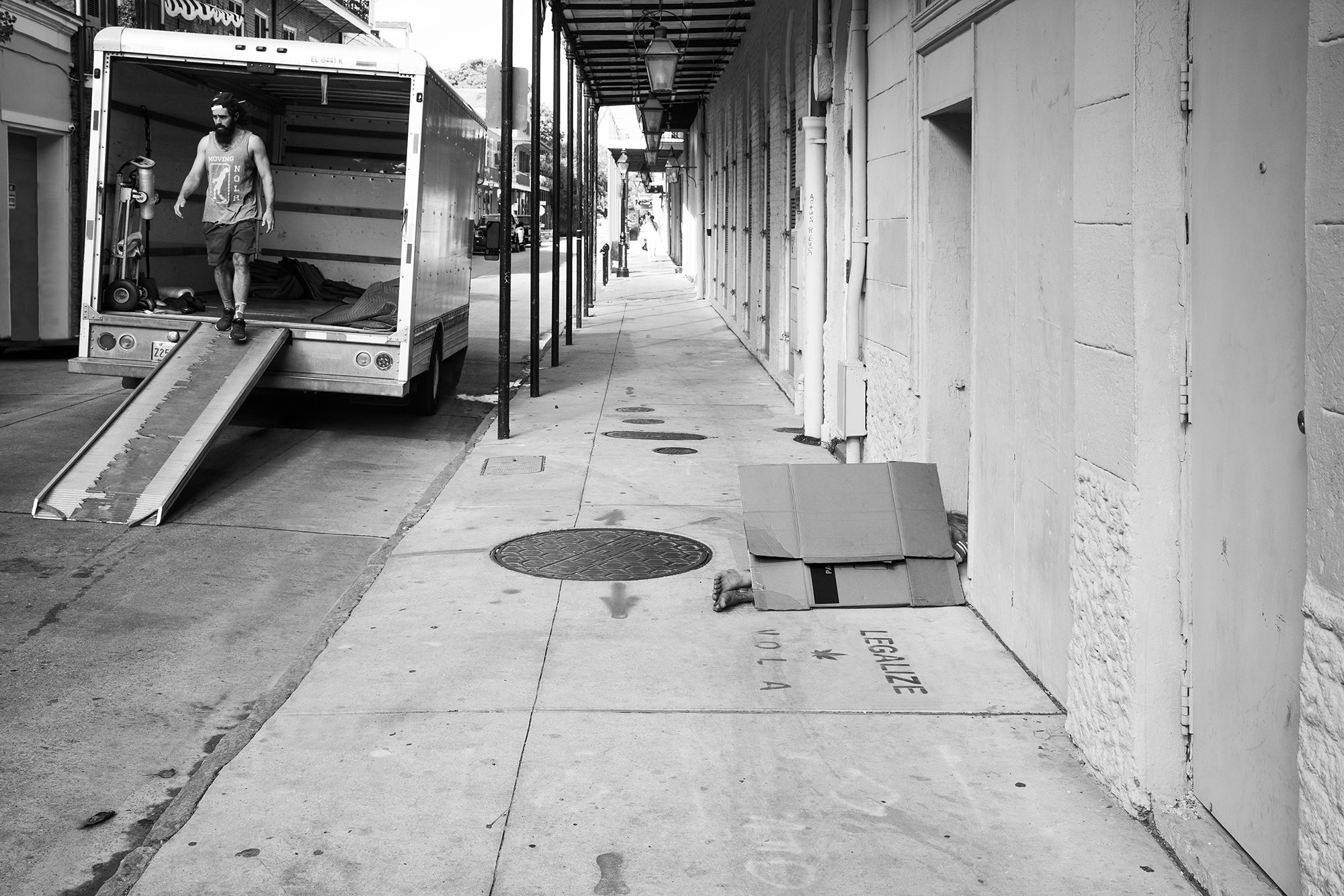 Homeless Person and Moving Truck, French Quarter, New Orleans, Louisiana, USA