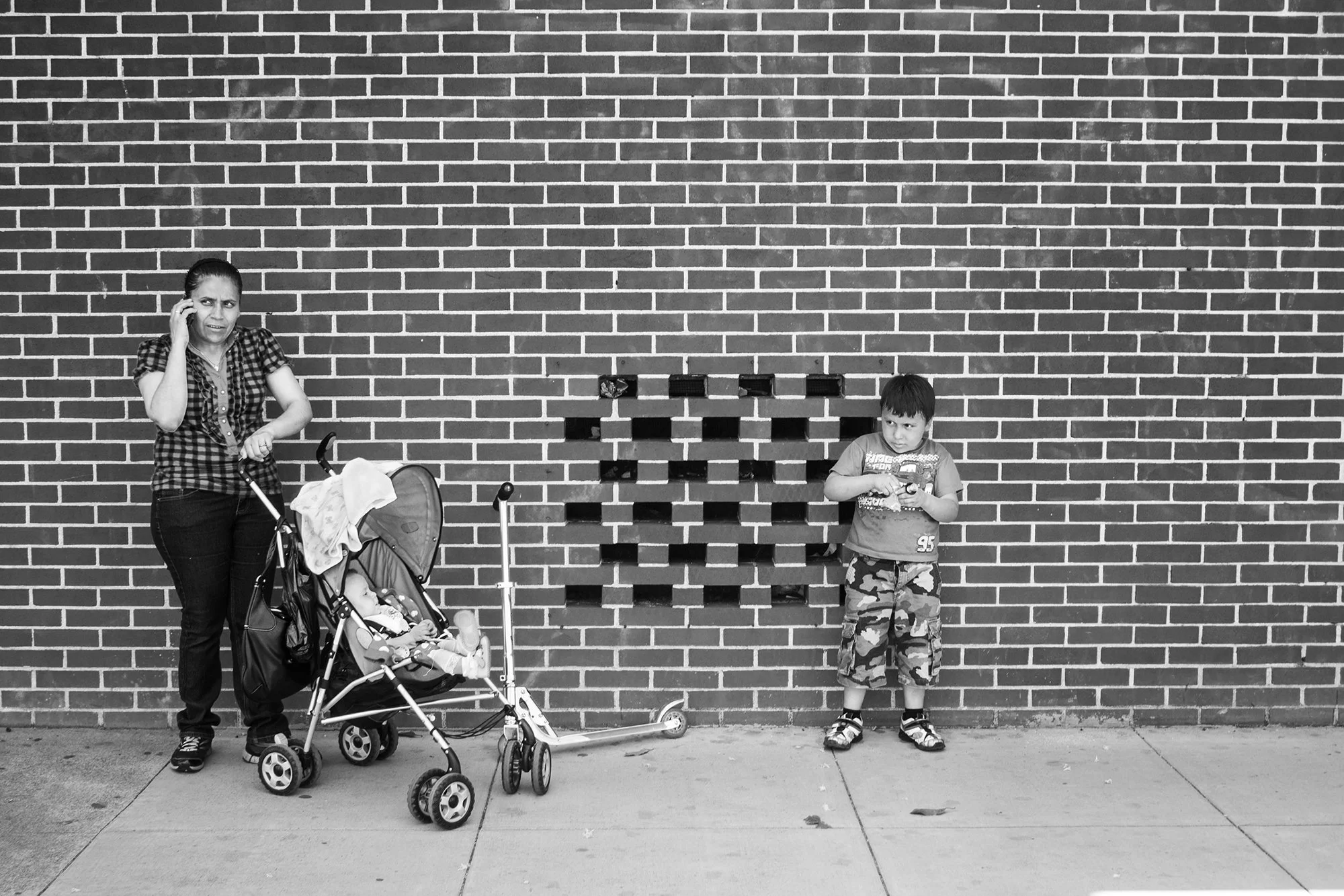 Woman and children looking at something suspiciously in the Mission District, San Francisco, California, USA