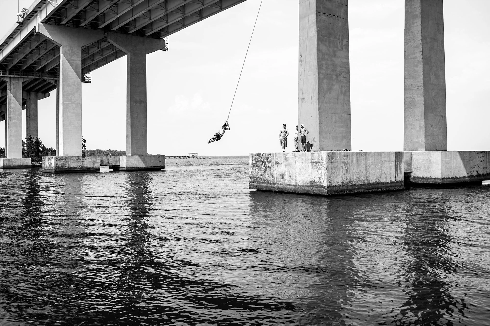 Kids playing under bridge, Mobile, Alabama, USA