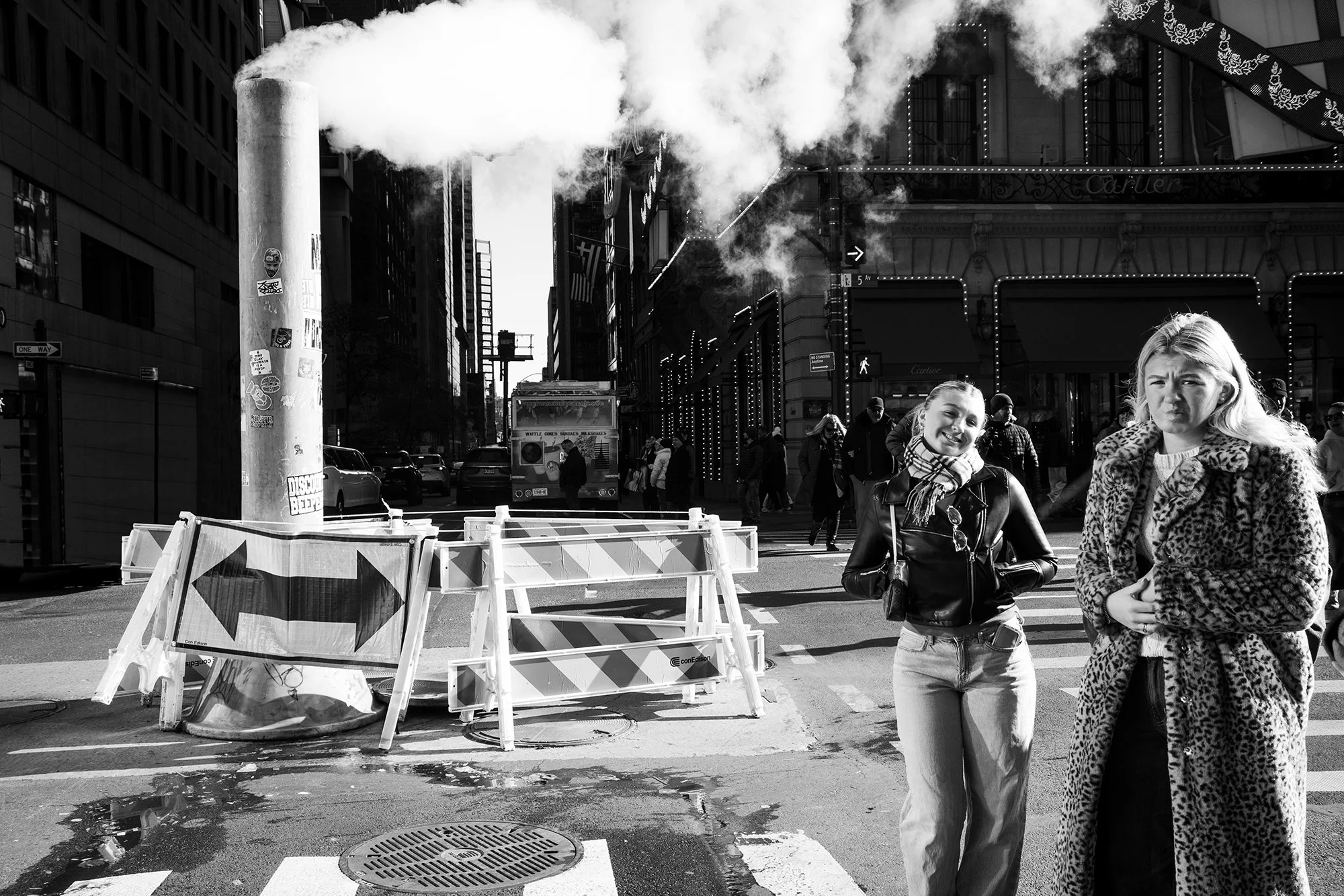 Mother and daughter next to steam column, New York City, USA