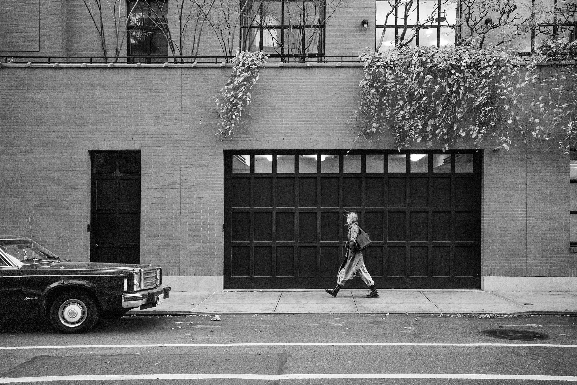Lady walking by vintage car Ford Granada, New York City, USA