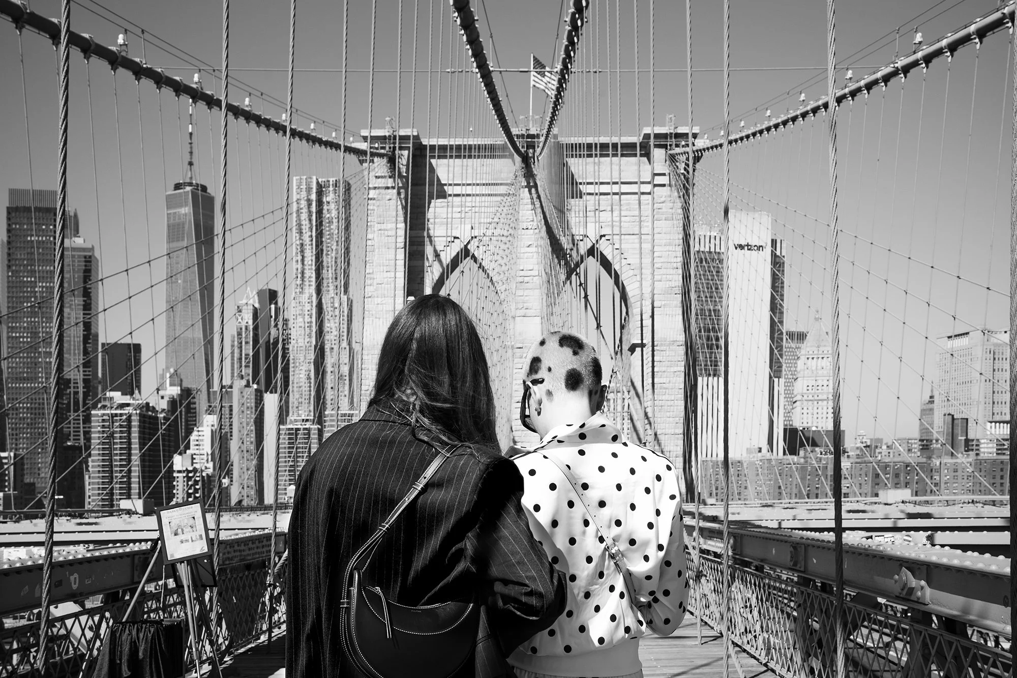 Girl with polka dot hair and polka dot jacket on Brooklyn Bridge New York USA