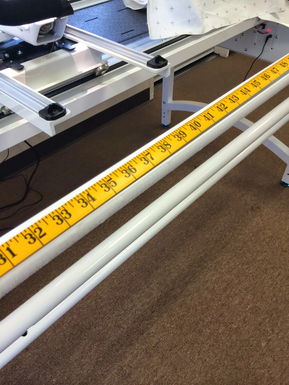 You may need a friend for this step. They can help you hold the tape measure. Or you can hold in place with painters tape. Measure each frame rail. Mark center. We used blue painters tape on the store frame. At home I used a fine line Sharpie red marker.