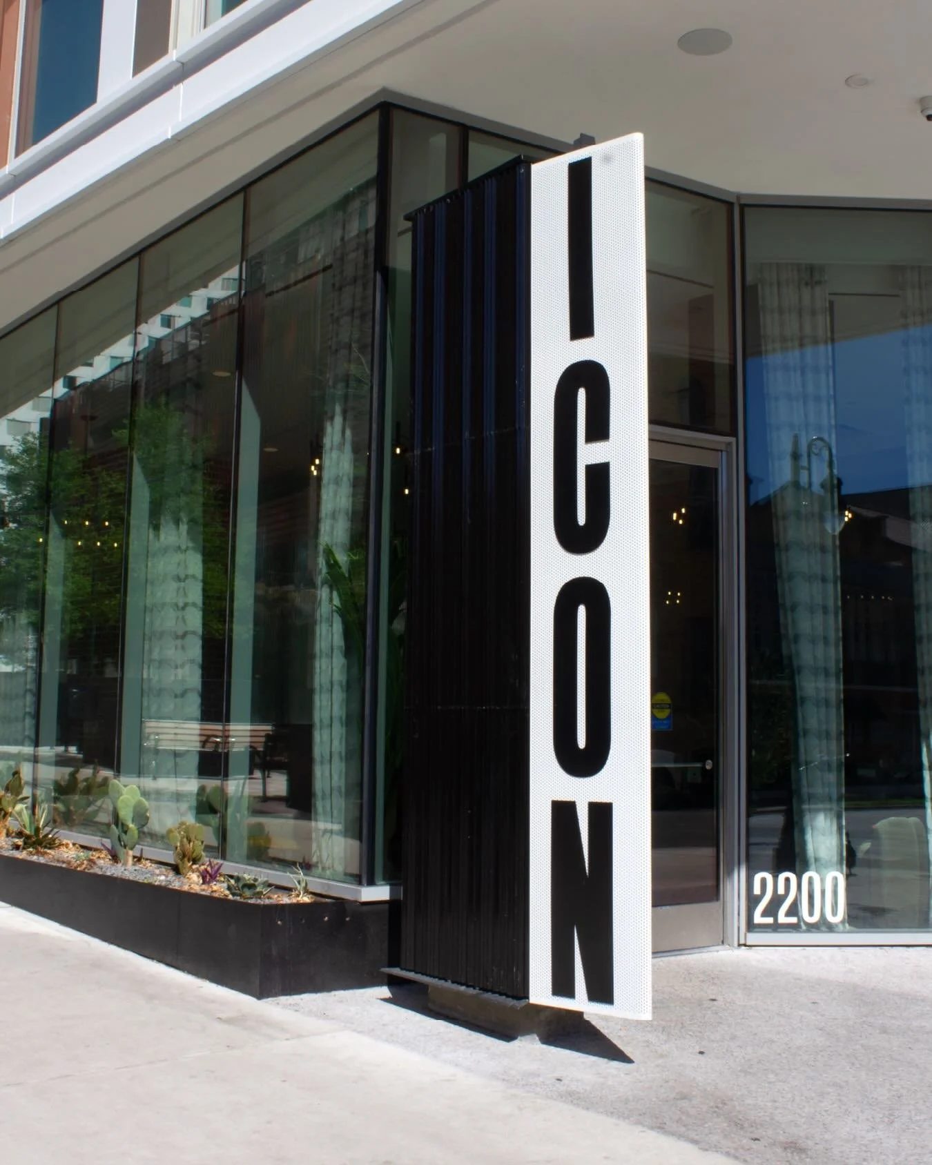 Part monument sign, part building sign &mdash; this 12-foot-tall custom illuminated feature was designed to function as both an architectural extension and a standalone landmark. Its triangular profile creates a double-sided experience for pedestrian