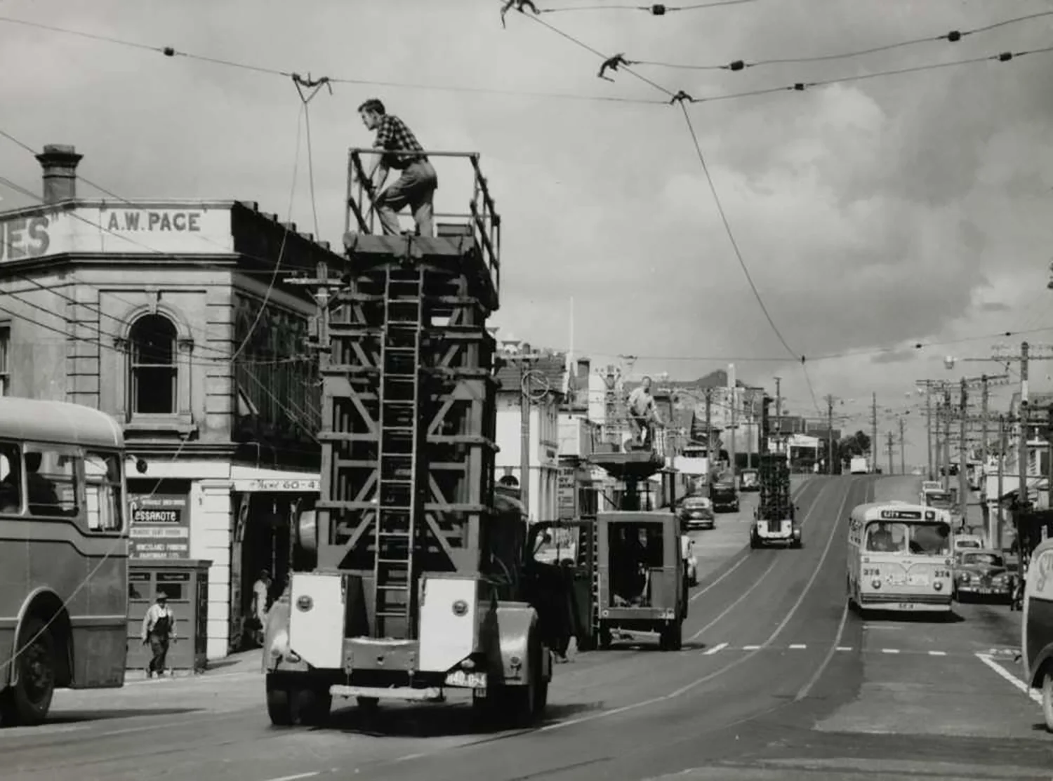 TRAMS REMOVED: Overhead tram wires removed in Kingsland in 1956 (Photo: Sir George Grey Special Collections, Auckland Libraries, 255A-55)