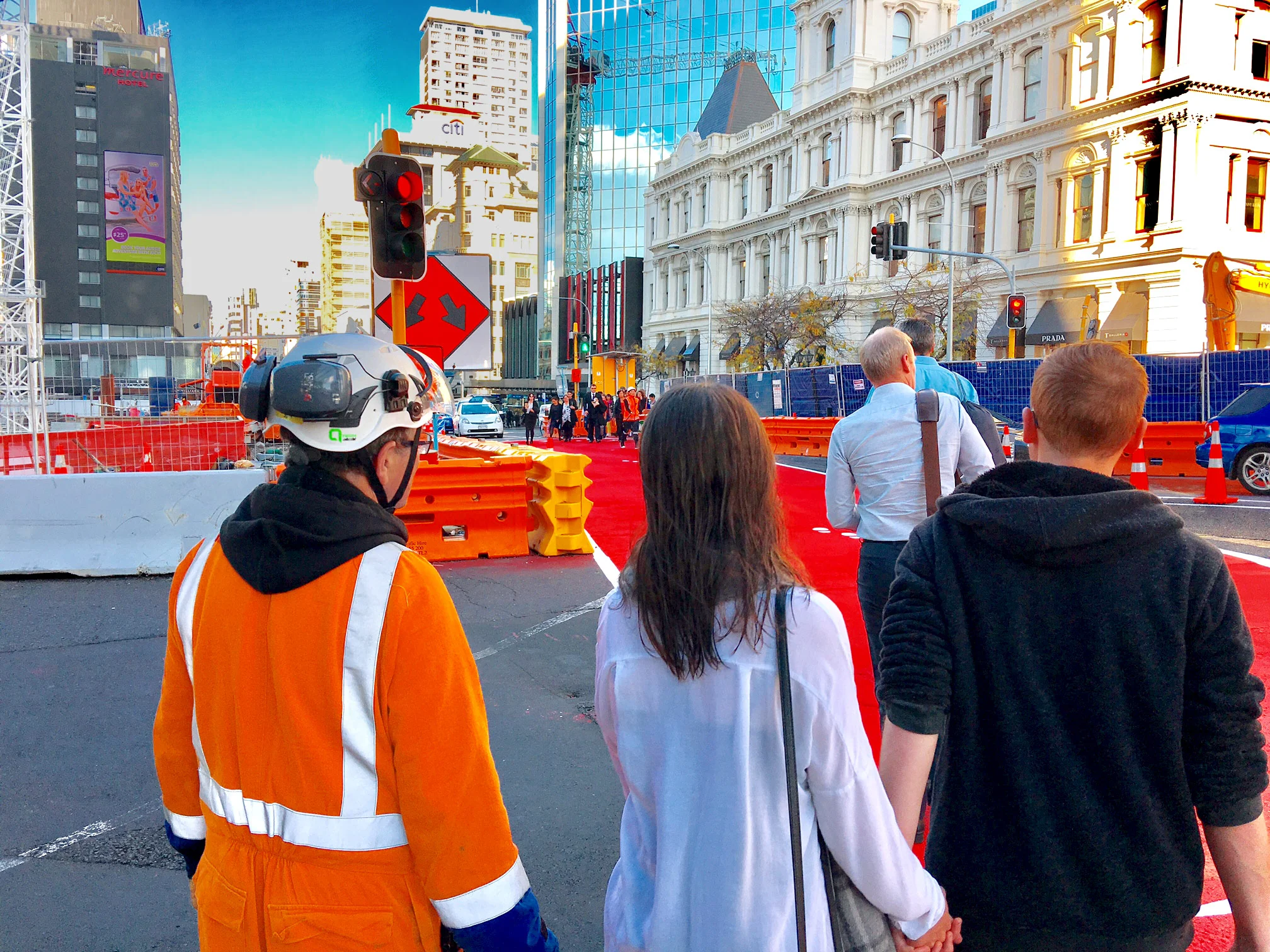 CROSS SAFE: Trained people are being used to assist people to cross safely at busy spots. Please follow their instructions