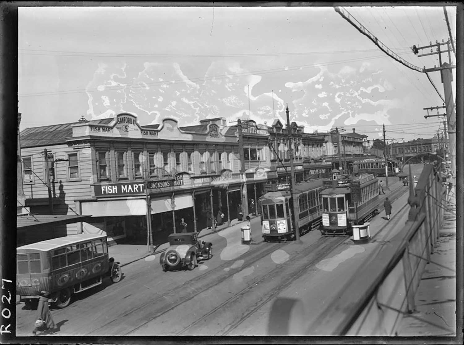   1925: Looking along Upper Symonds Street, showing trams and a bus running past the premises of Sanford Fish Mart (Photo: Sir George Grey Special Collections, Auckland Libraries, 35-R27)  