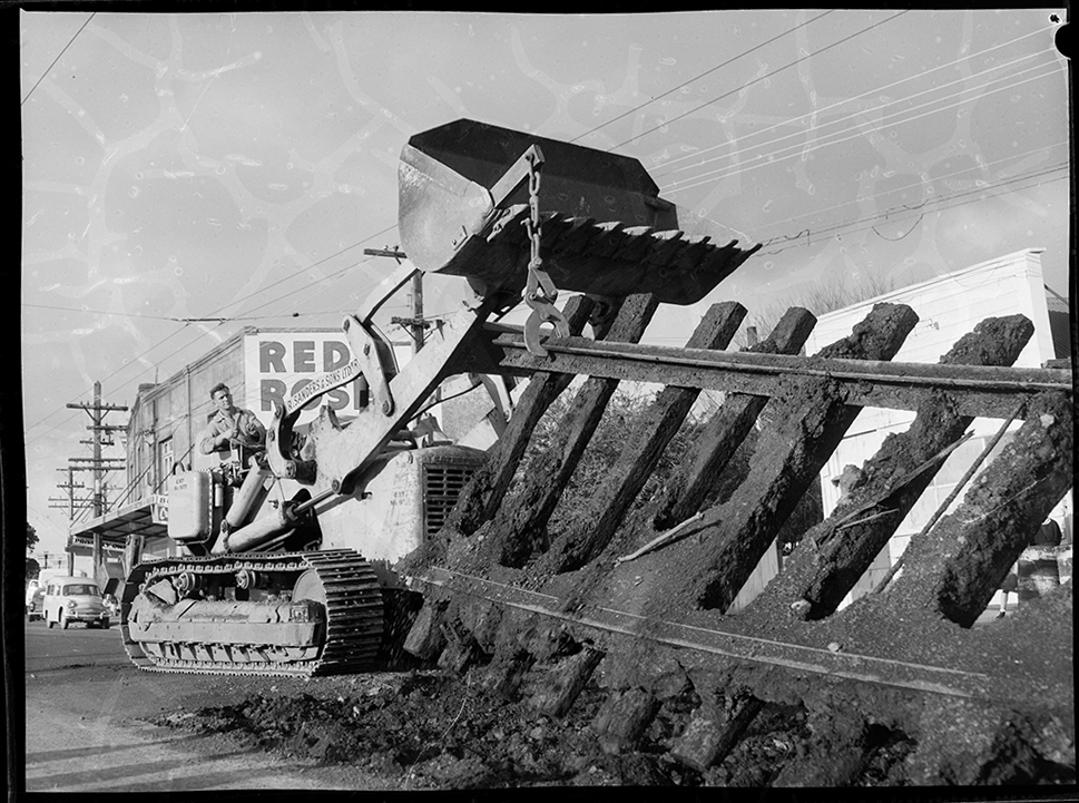   TRACKS: Tram tracks being removed in New North Road near the rail overbridge at Rocky Nook, Malvern Road in June 1960 (Photo: Sir George Grey Special Collections, Auckland Libraries, 1370-658-14)  