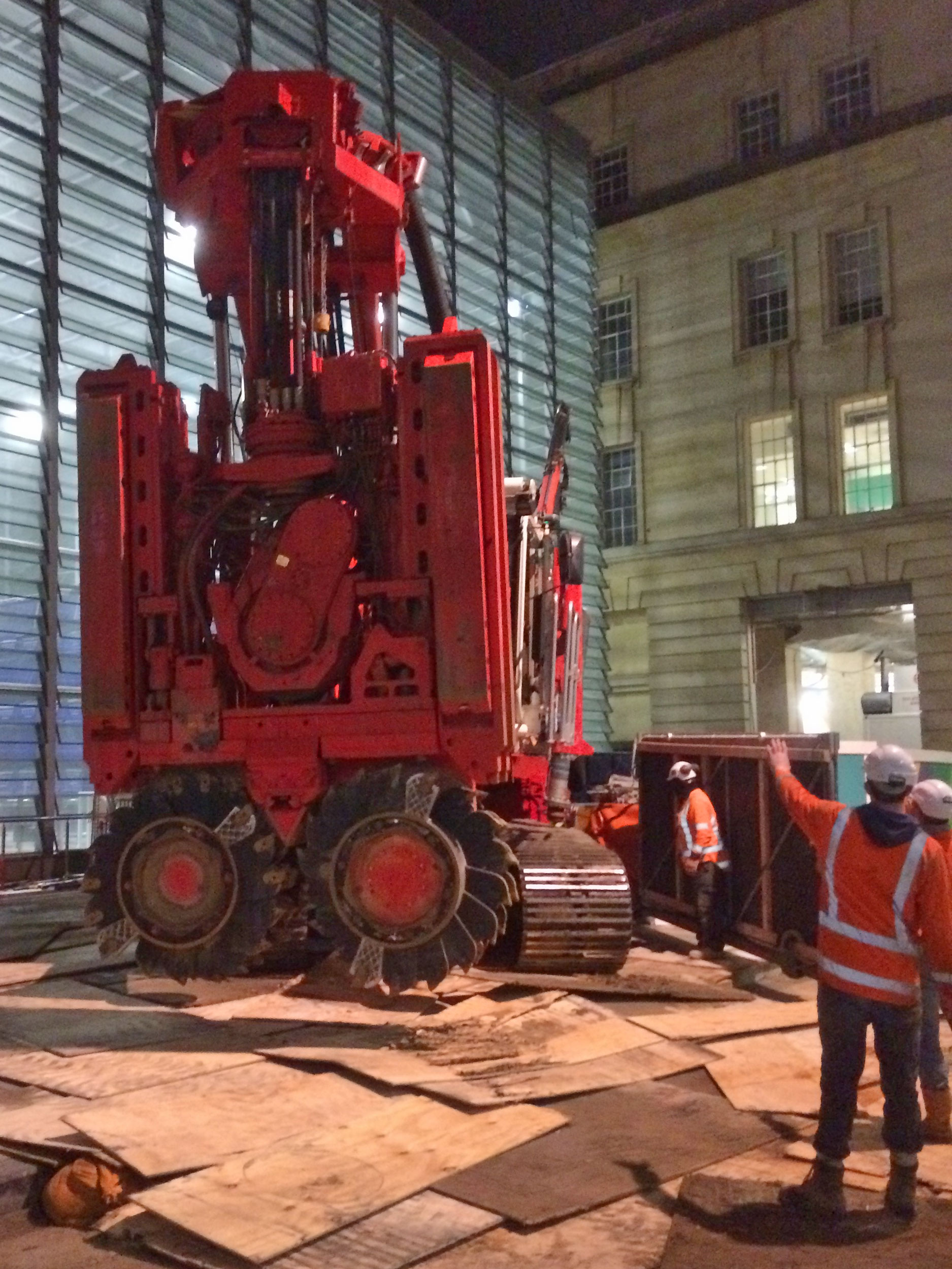  This bright red 90 tonne piling rig named Sandrine worked inside and outside the historic Chief Post Office (Britomart Transport Centre) building until being returned to France in early 2018. This is Sandrine being brought inside the building August
