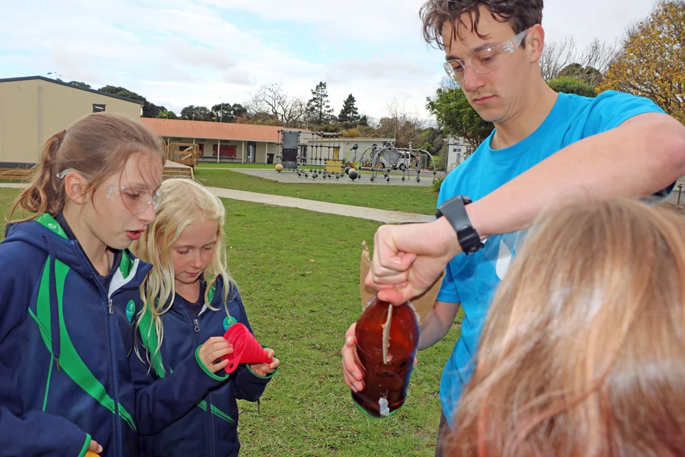   Isaac Devanney-Bray helps Pasadena students get their rocket ready for firing  
