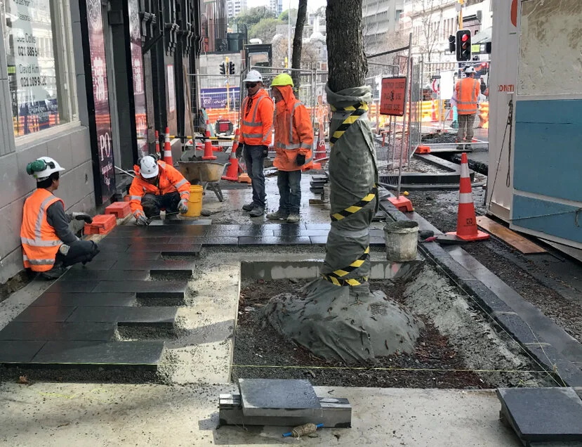 Contractors laying first pavers on Albert Street