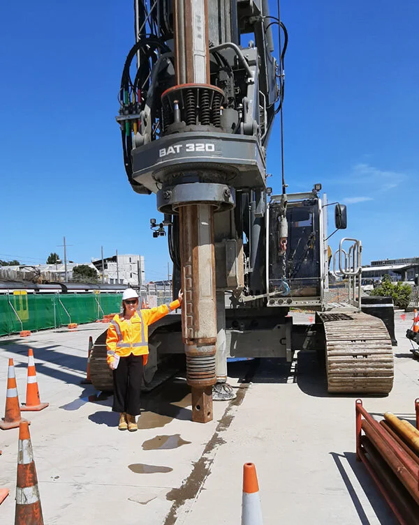 Piling rig with person standing beside it