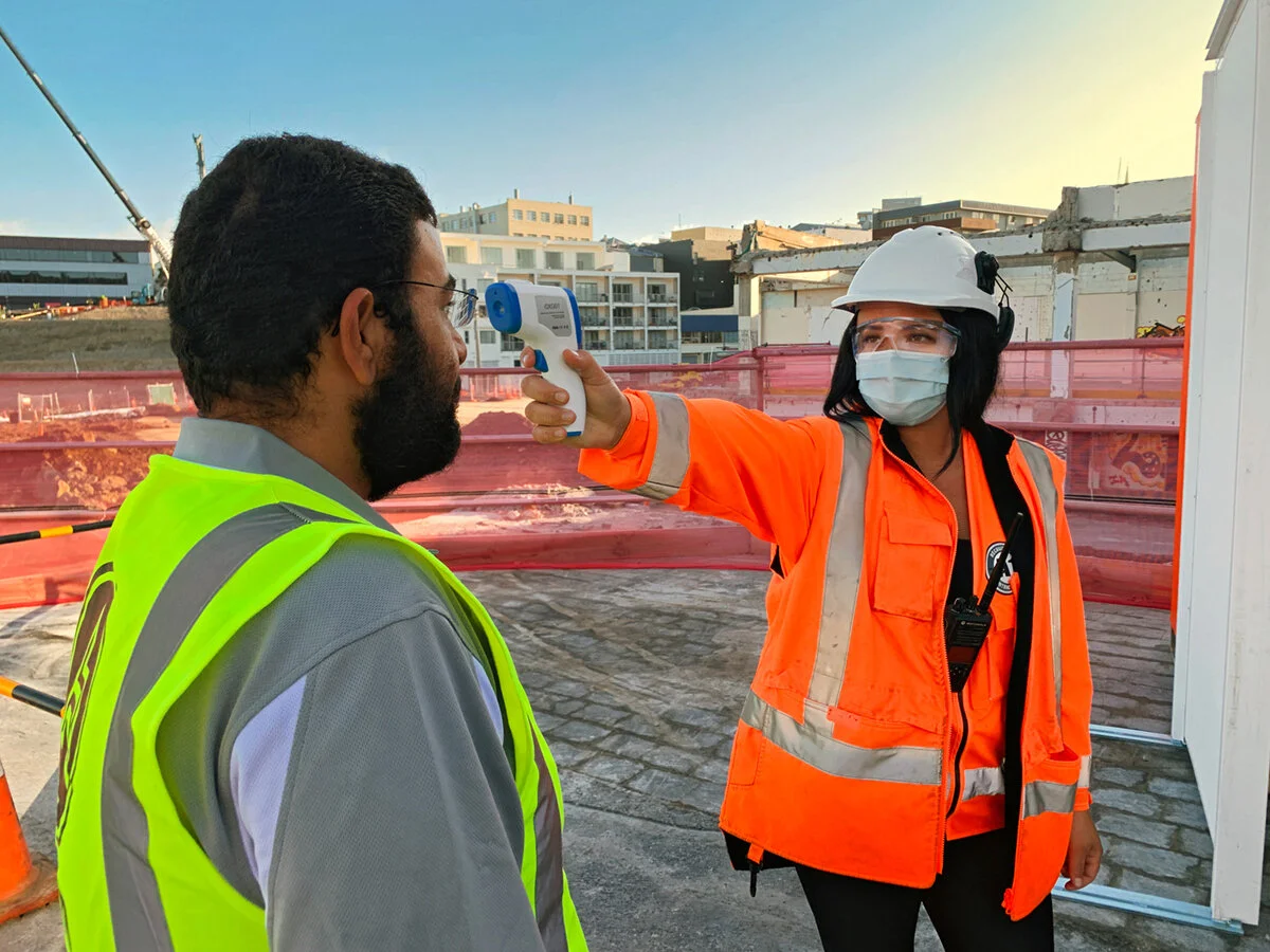  Workers have their temperatures checked before entering site 