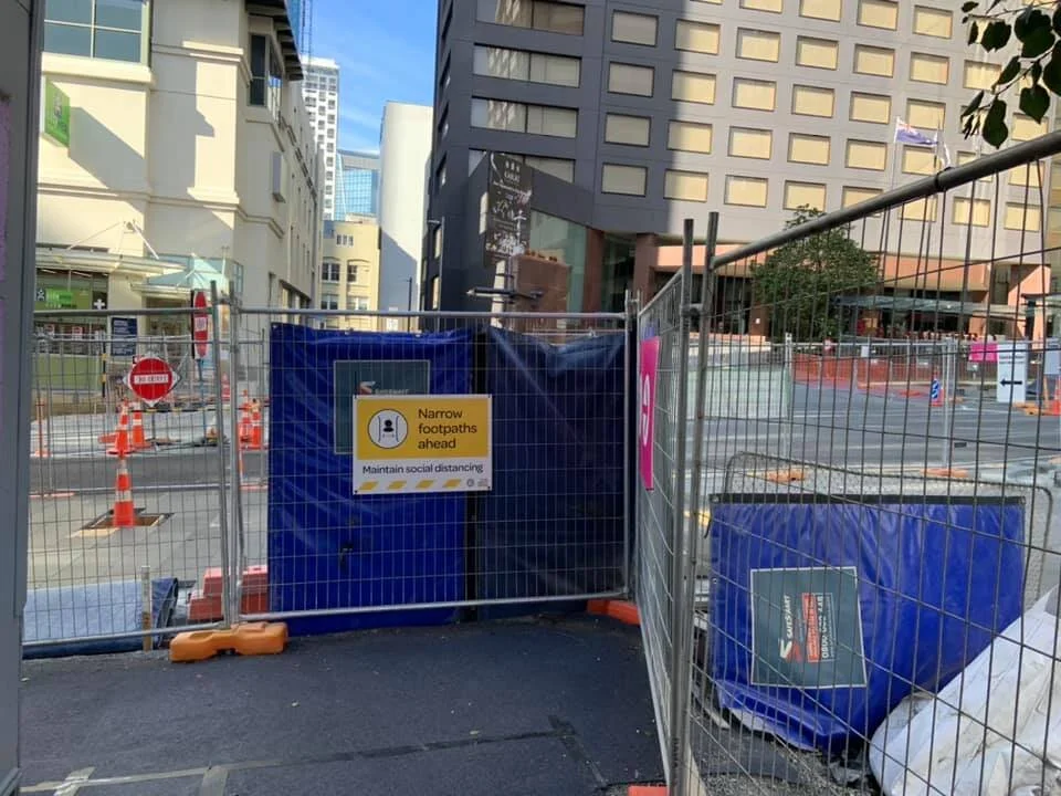 Fencing on Albert Street with CRL signs reminding people to maintain social distancing