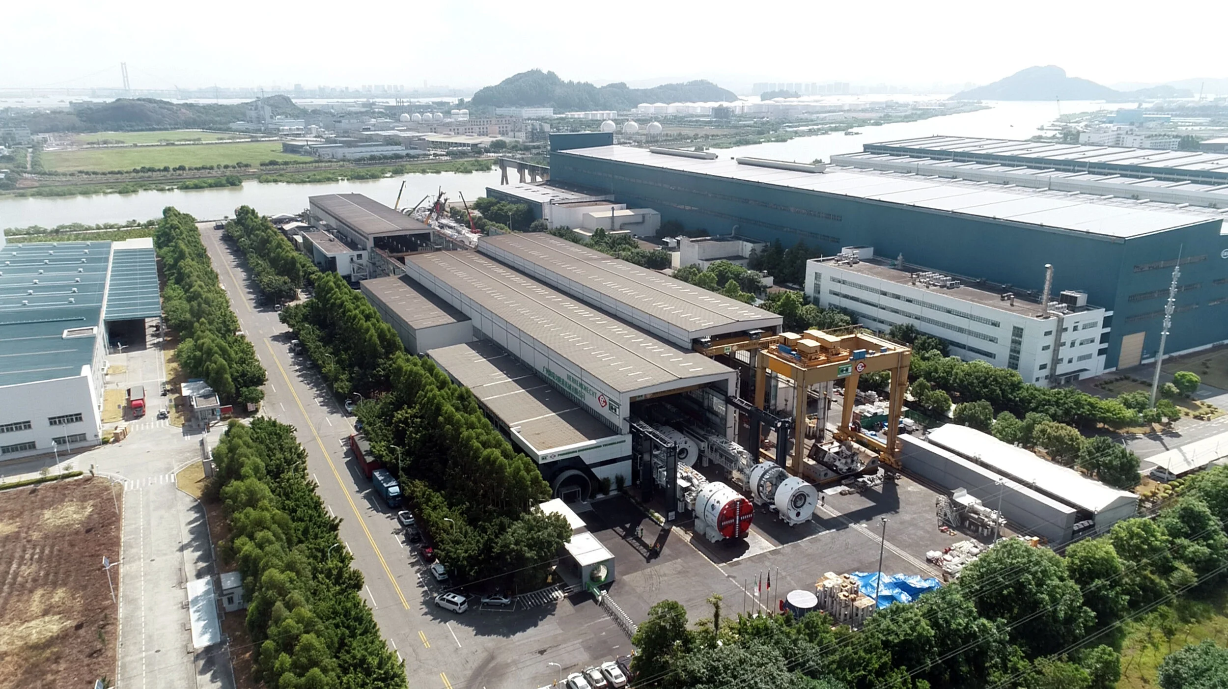 Aerial photograph of the factory building in China with the cutter head of the TBM showing at one end