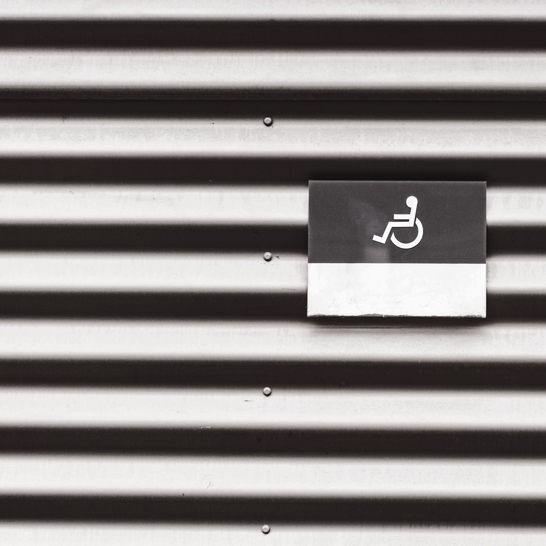 metal-wall-with-wheelchair-disabled-sign-picjumbo-com.jpg