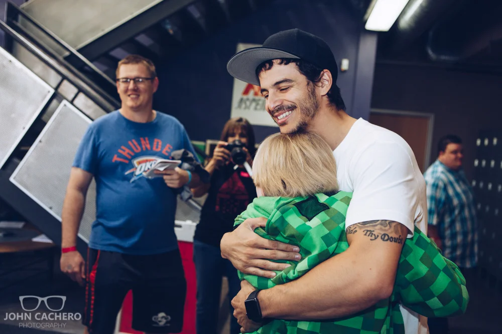 Ninja warrior, Flip Rodriguez, hugging it out with a fan.