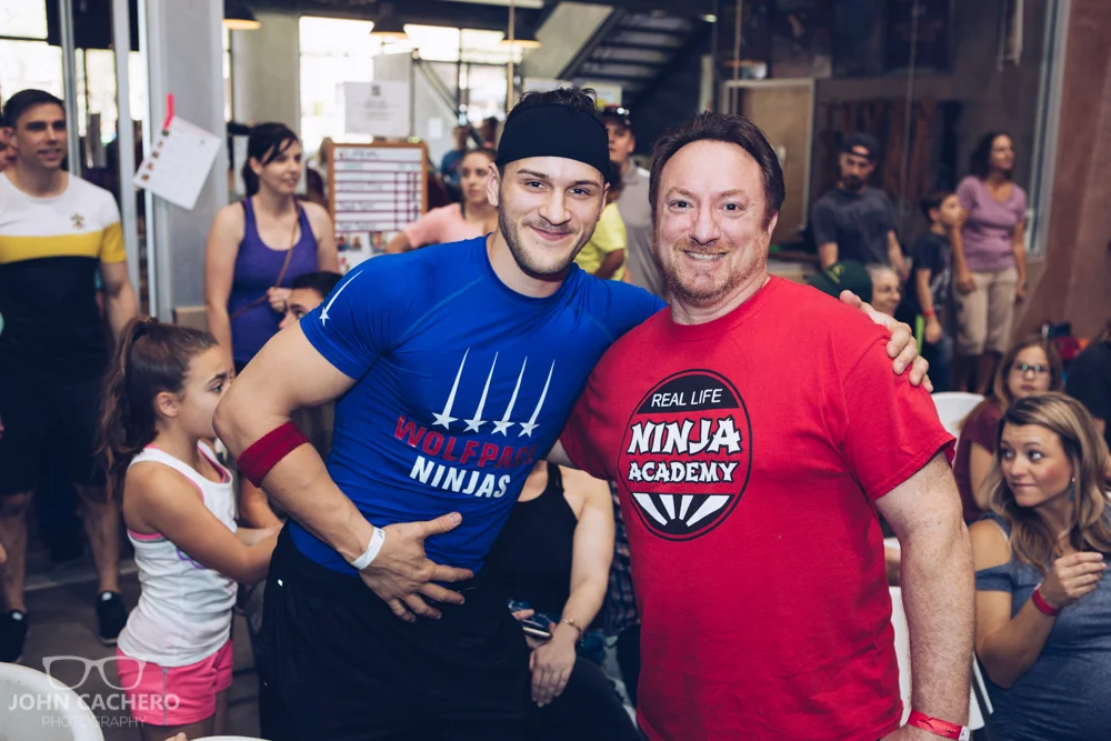 Ninja warrior, Adam Rayl, posing with a fan in the crowd.