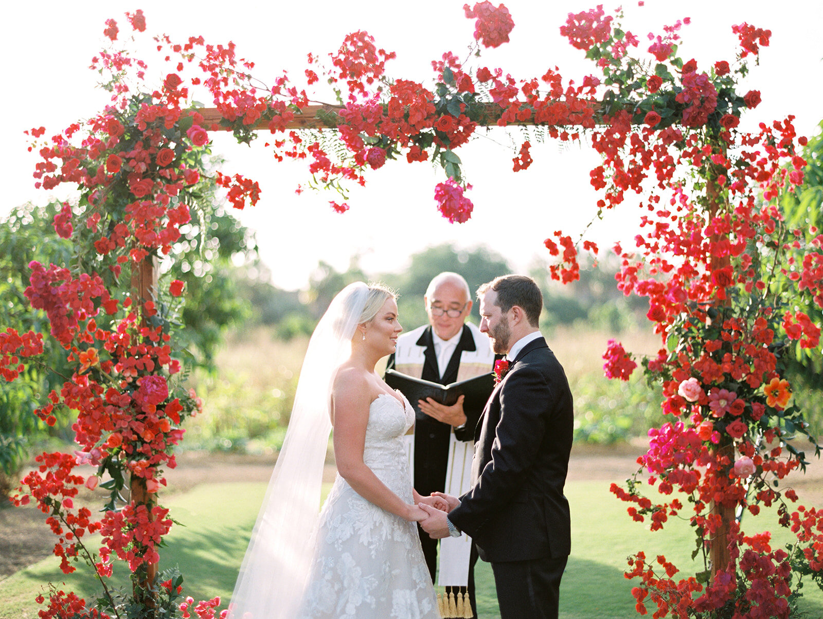 wedding ceremony arch tropical vibrant flowers