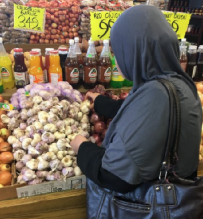 Afeefa shopping at the local Orange Farmers Market for ingredients to use in Sanctuary Kitchen Cooking Classes.