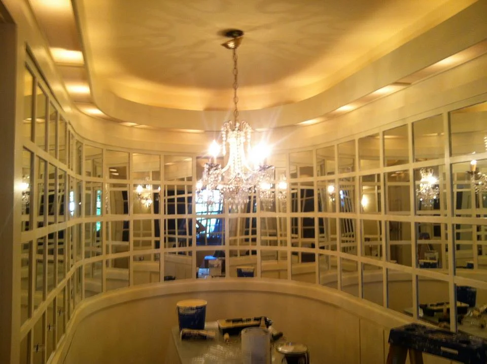 This uniquely shaped oblong mirrored dining room was a challange to restore and paint.