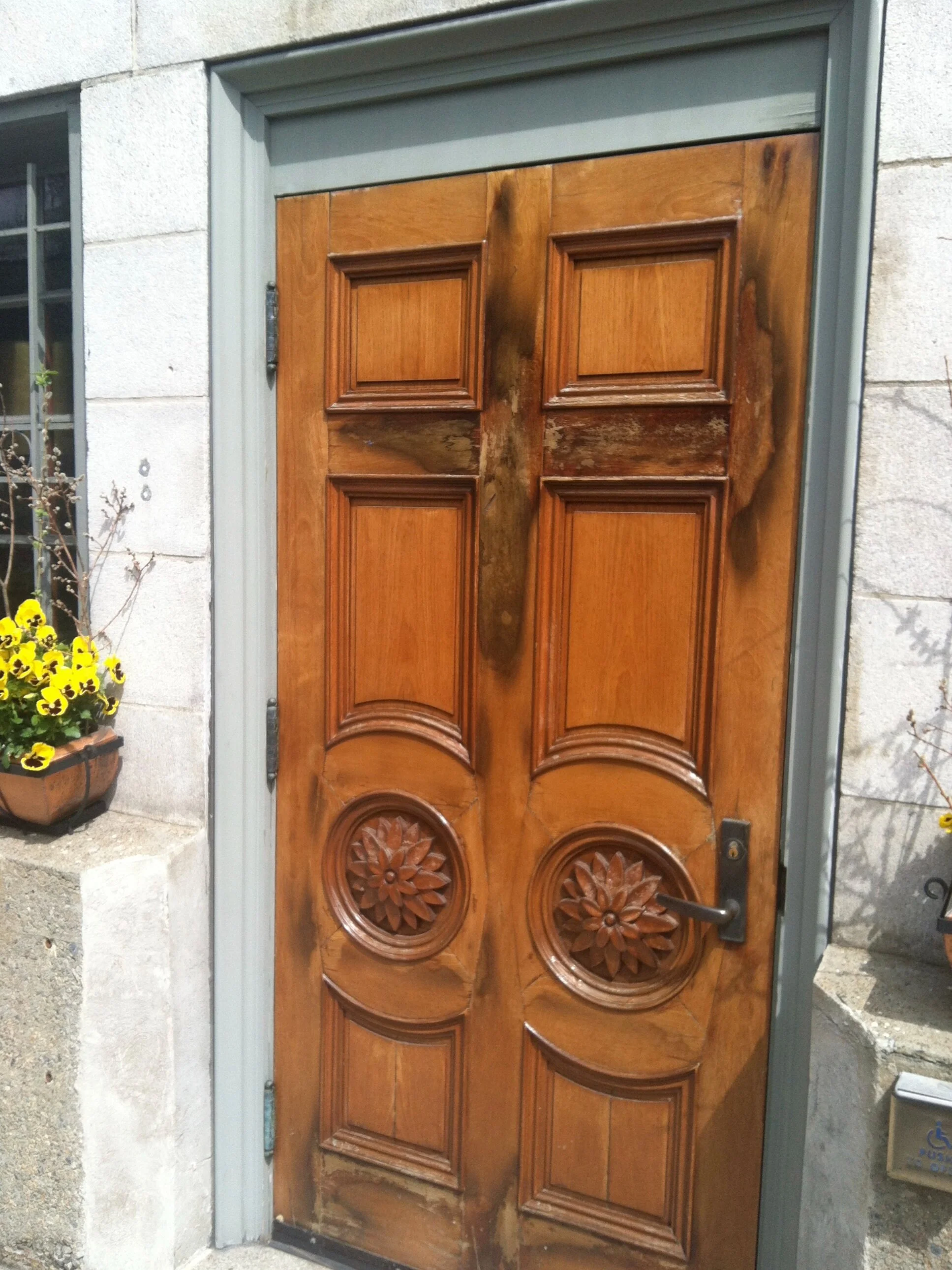 Before - These mahogany doors had been exposed to the elements to the point that the mahogany color was completely bleached from them. The doors also had a fair amount of water damage.
