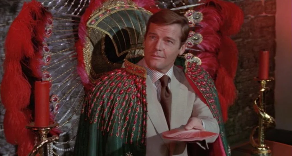 Roger Moore sitting in the Tarot throne from Live and Let Die