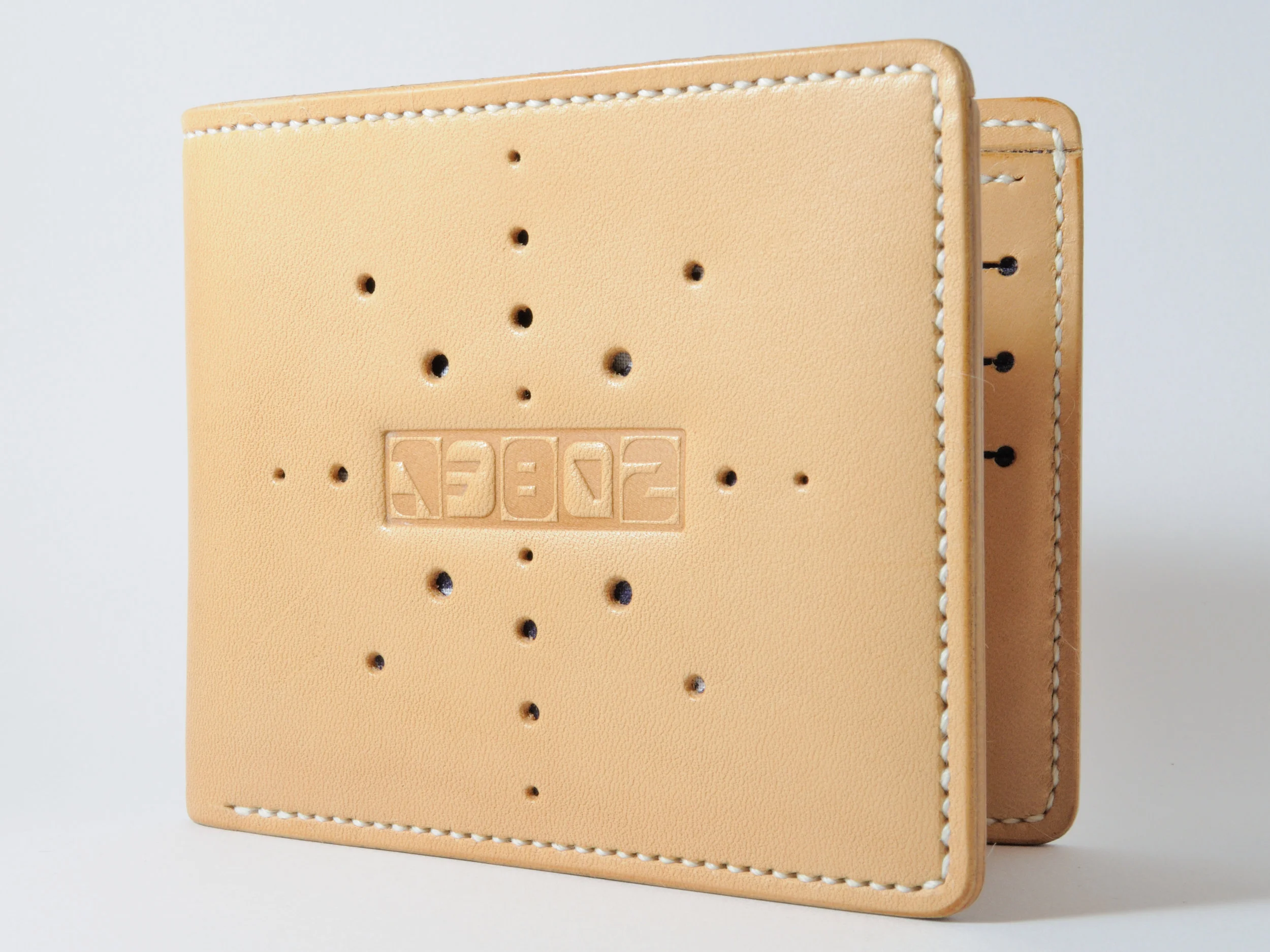 Natural leather w/ sunburst hole punched pattern & navy bandanna liner