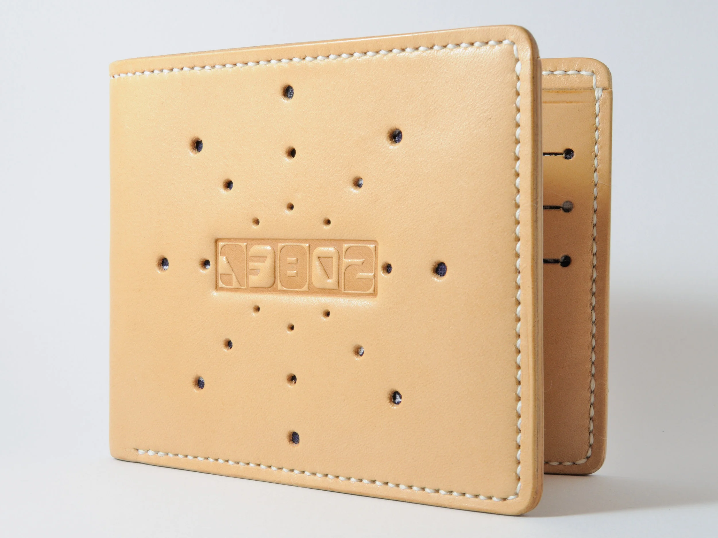 Natural leather w/ sunburst hole punched pattern & navy bandanna liner