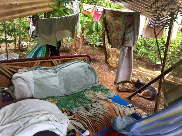 Lady with 3 children living under shed roof in Cristo Rey. We built her a new home.