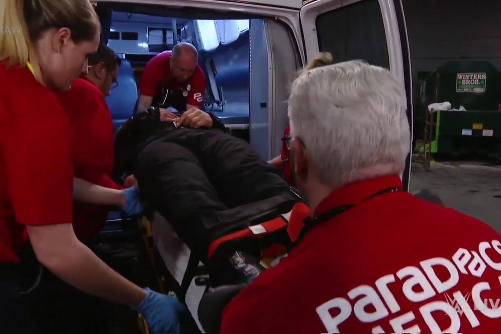 ParaDocs crew loads injured WWE Superstar Roman Reigns into an ambulance.