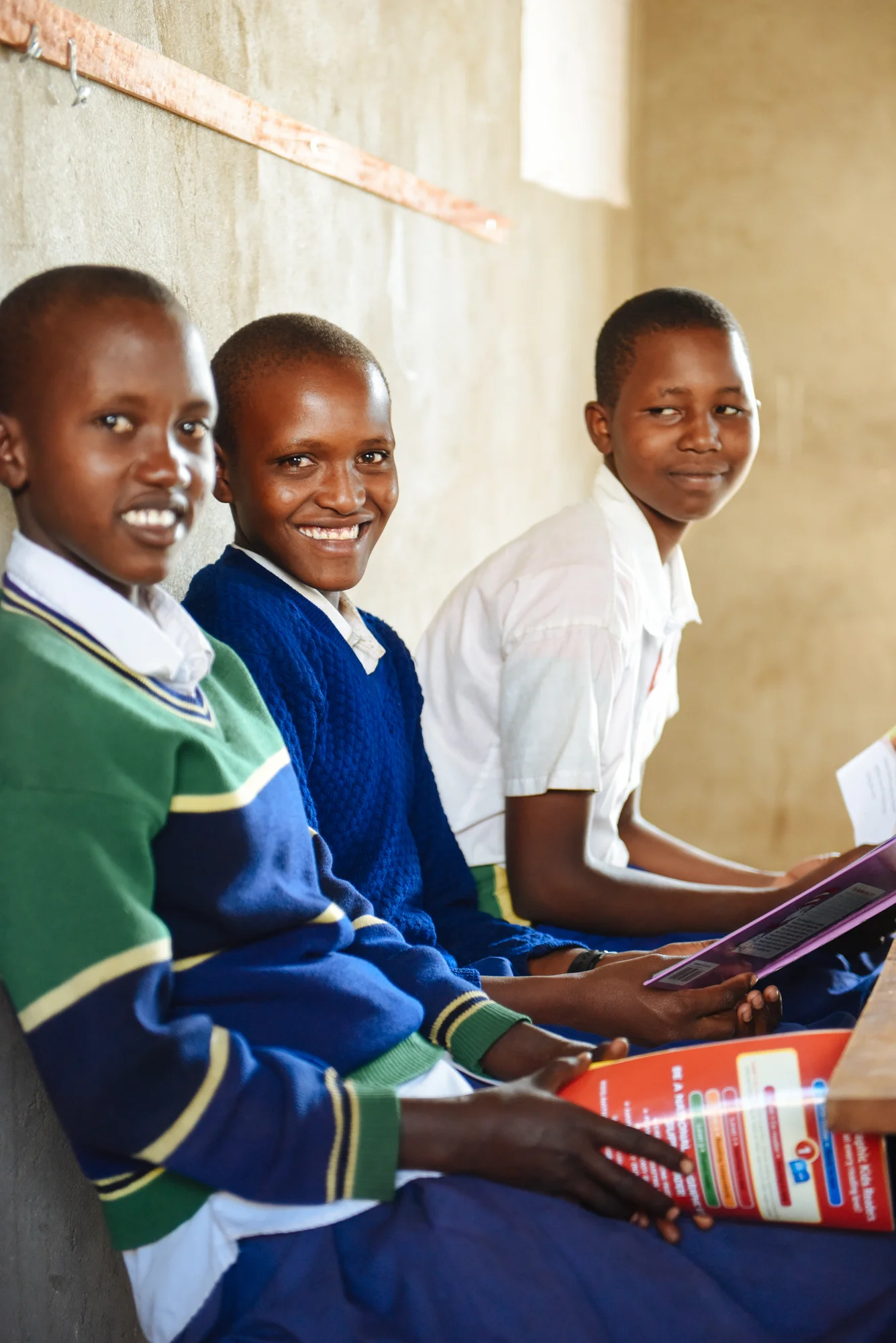 Martha, center, smiles during her Standard 7 class at Mlima Shabaha School.
