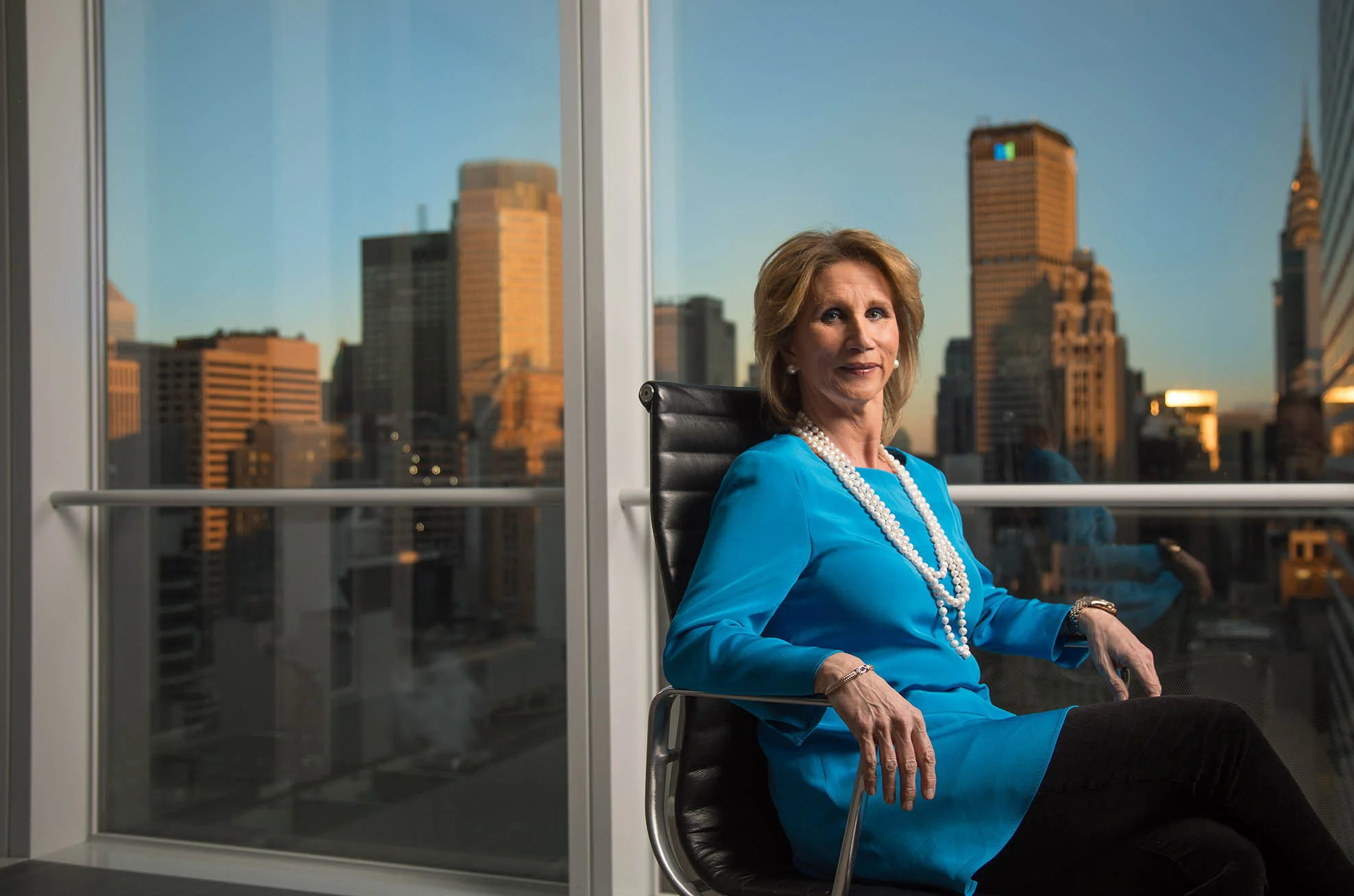NYC executive sitting in front of skyline