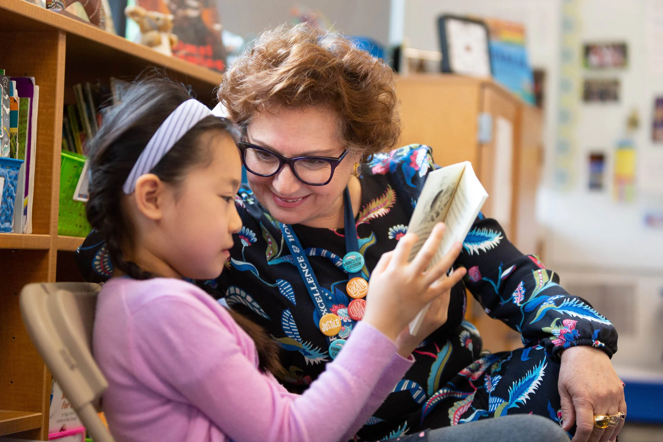 A teacher talks with a student in a private school marketing photo.
