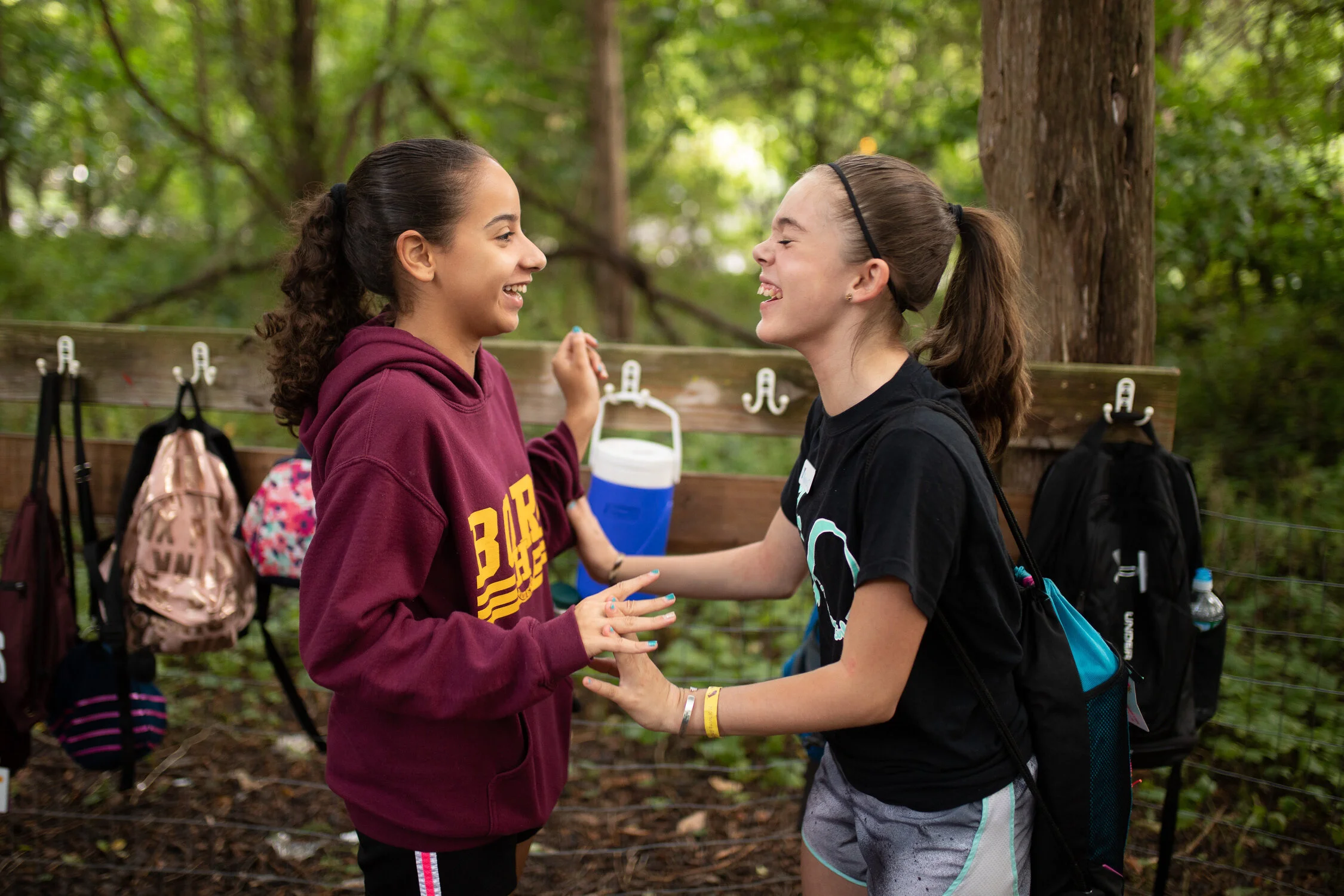 A candid photo of two students at a summer camp.