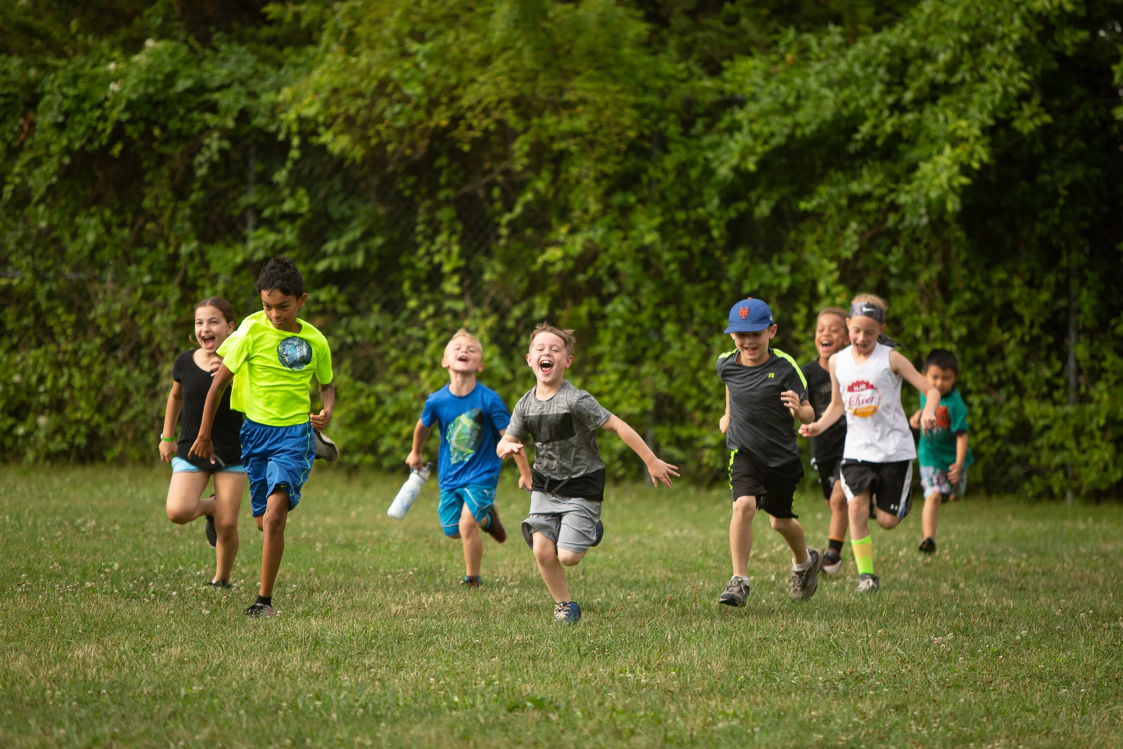 Students running a race in a marketing photo for a summer camp.
