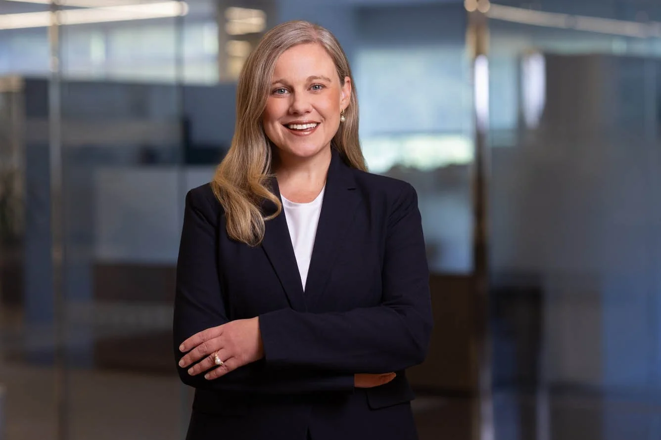 Portrait of a female executive with a modern office as the background. 