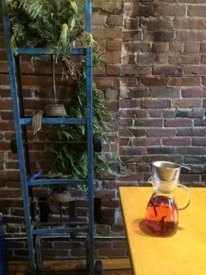 Enjoying hibiscus tea and plant-inspired decor.