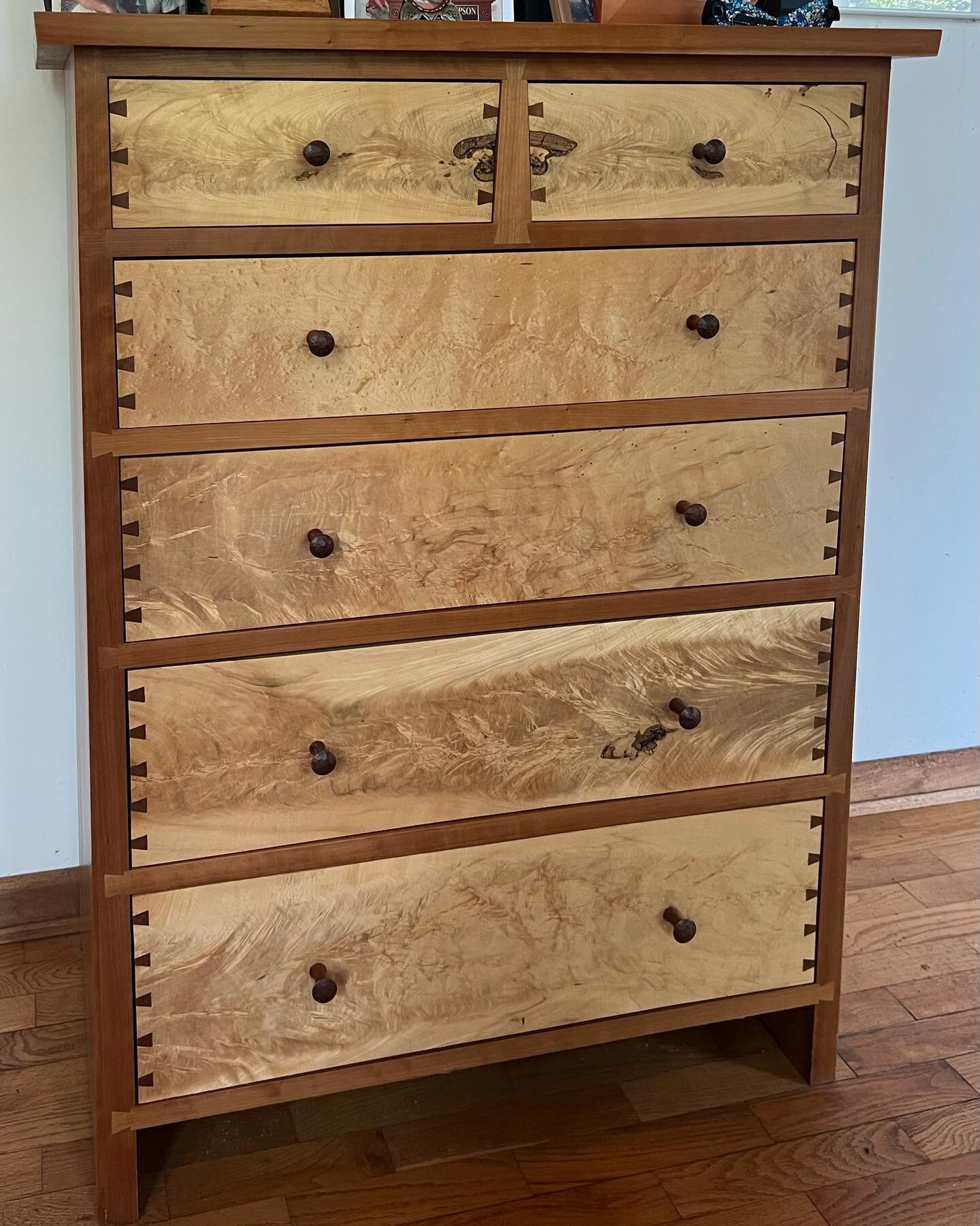 I visited some old work today. This chest was made about 10 years ago from wood I milled years before that. Sugar maple crotch (solid) drawer fronts in a cherry carcass. Good to see it well loved by our friends.