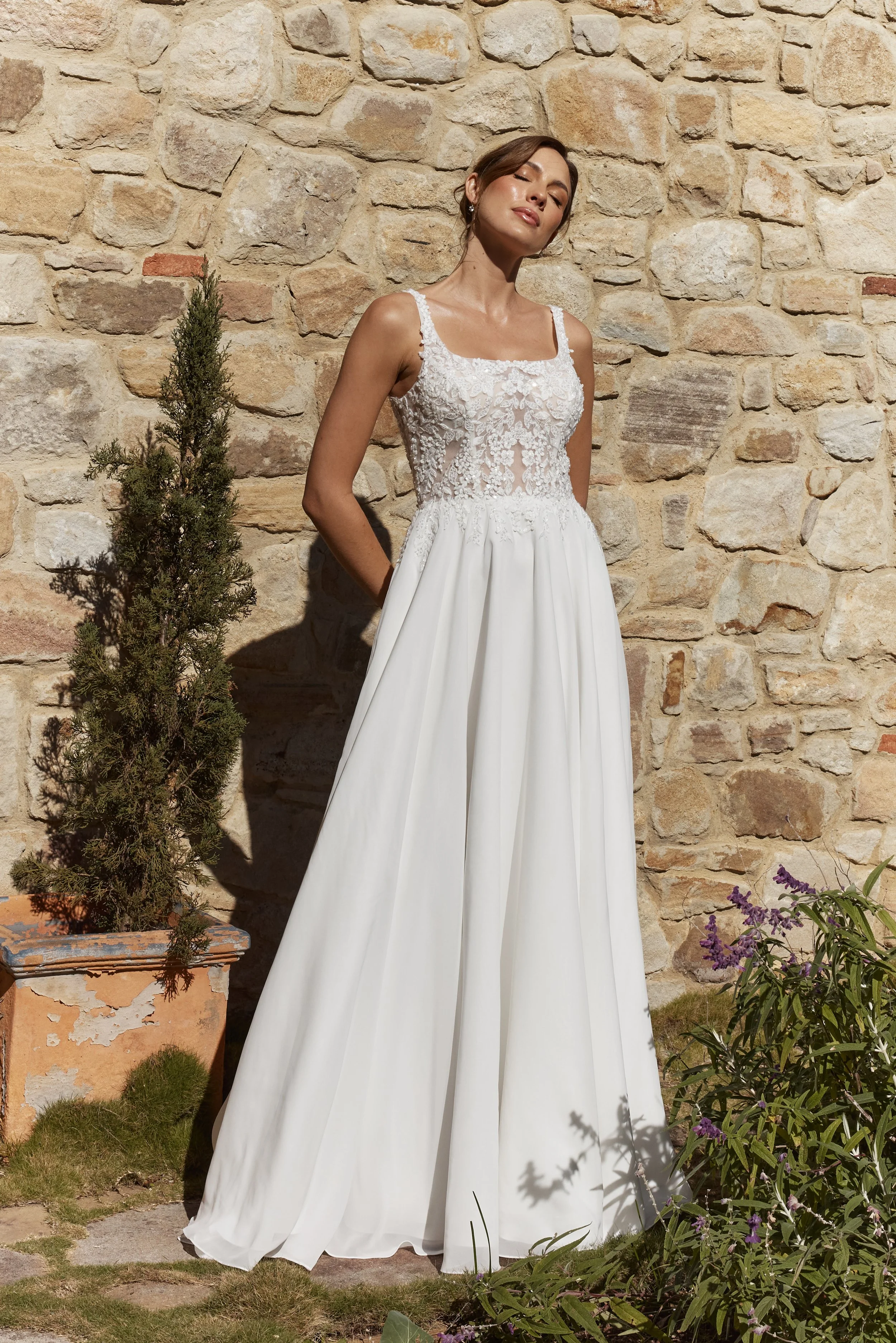 Zinnia A-line wedding dress in soft georgette with square neckline, lace appliqué bodice and flowing chapel train