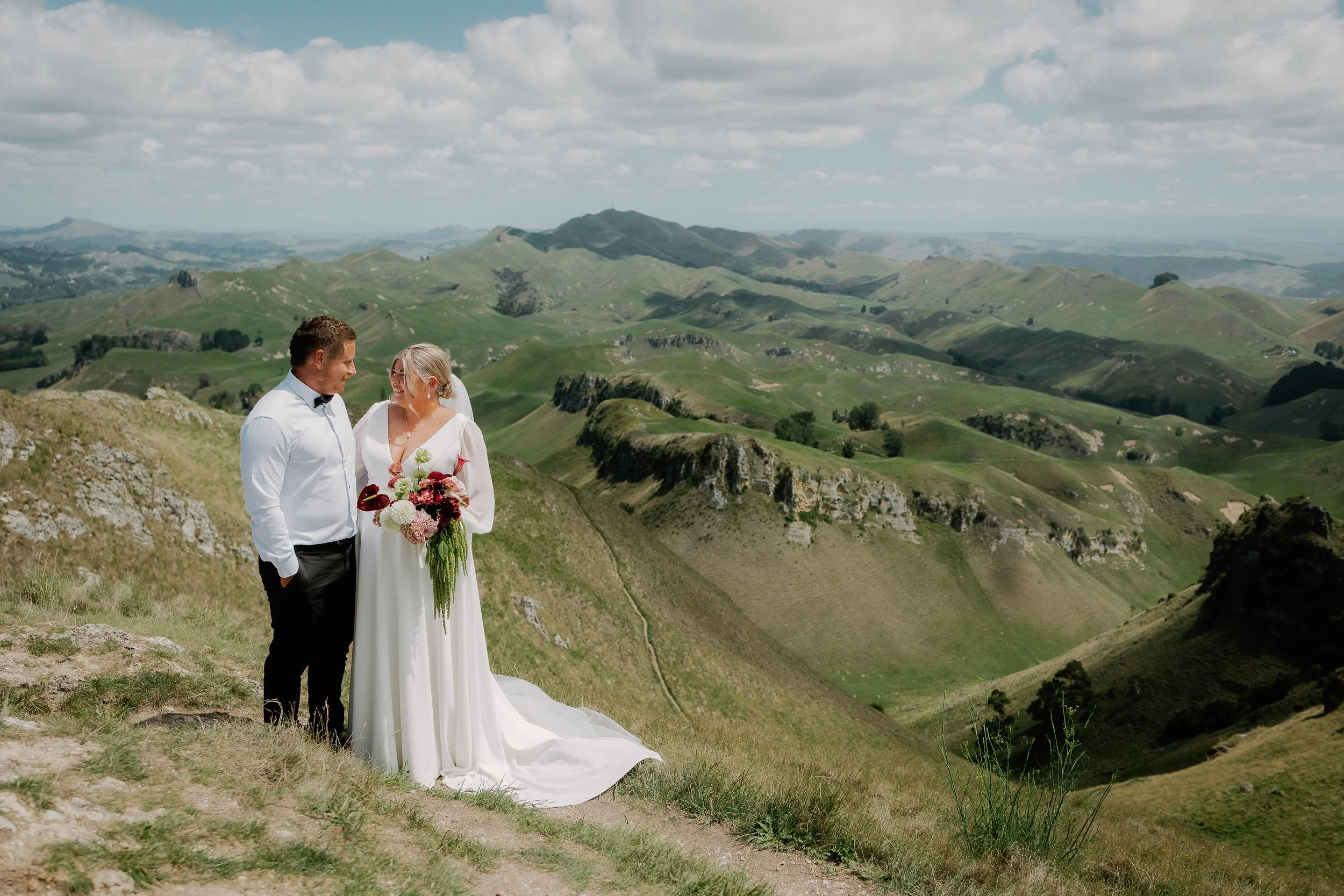 Bride and groom on mountain top.