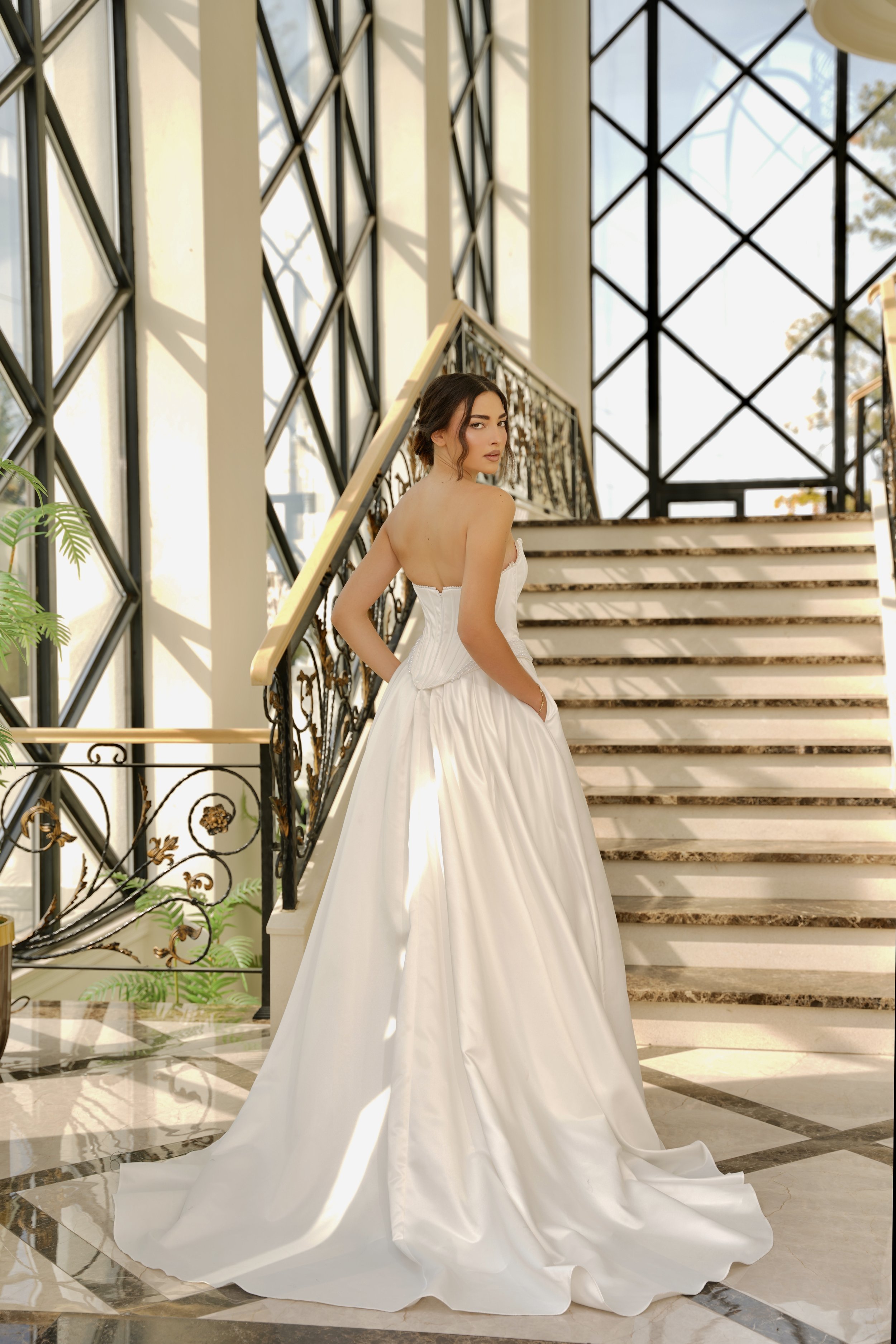 Delicate pearl detailing traces the neckline, adding a soft, romantic finish.