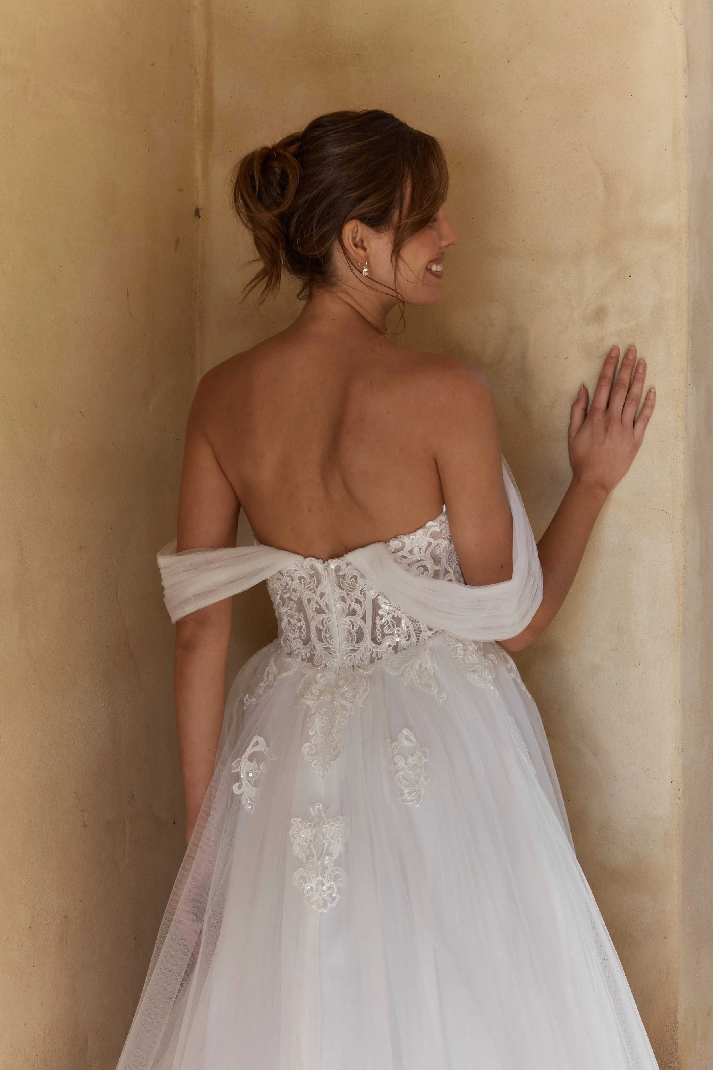 Starflower romantic A-line wedding dress with scooped lace bodice, gathered off-the-shoulder straps and illusion cathedral train  Closeup of back