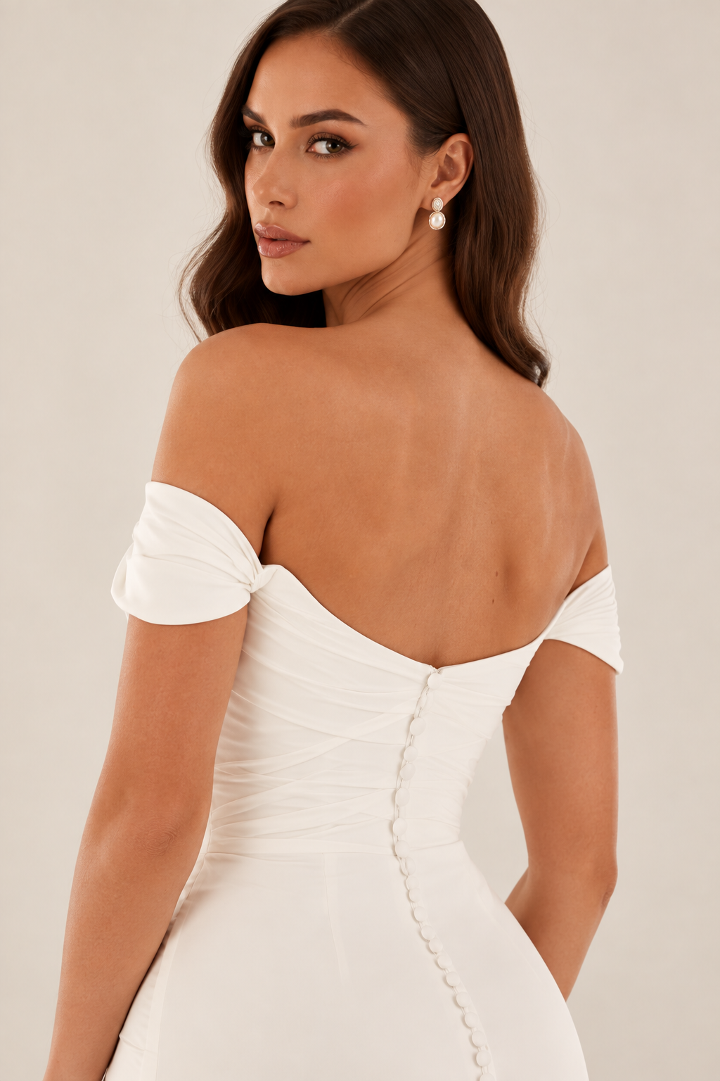 Tavelle bridal gown with off-the-shoulder neckline, buttons adorn the back bodice and fitted silhouette