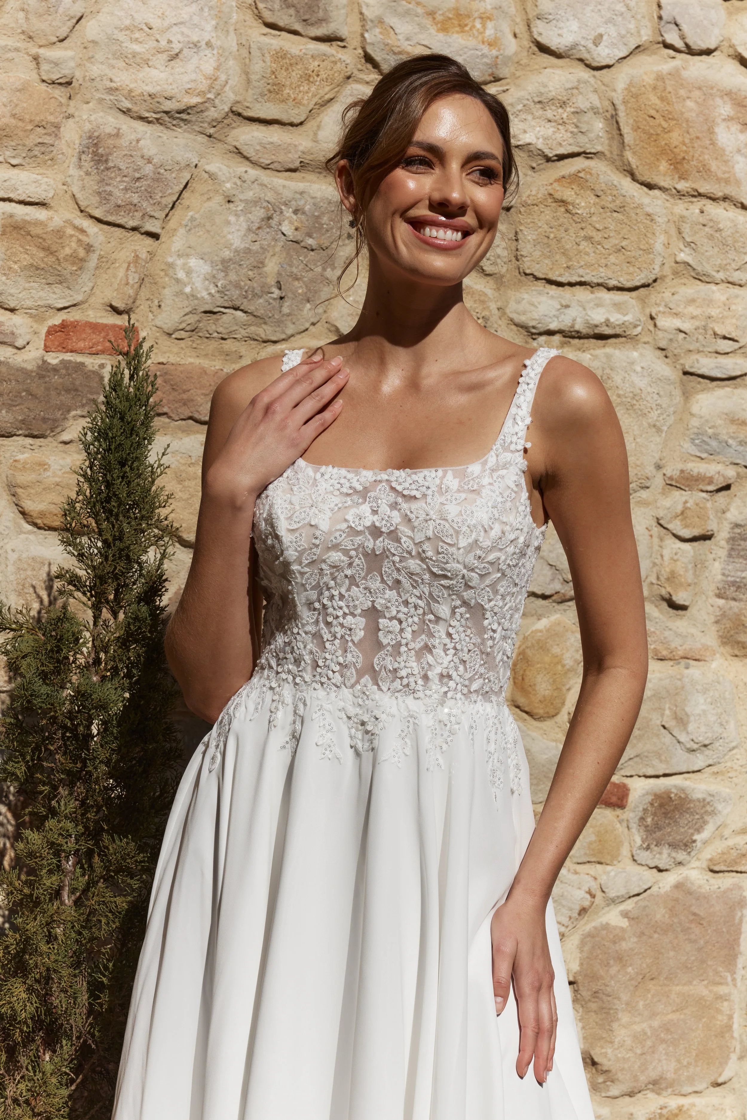 Zinnia A-line wedding dress in soft georgette with square neckline, lace appliqué bodice and flowing chapel train