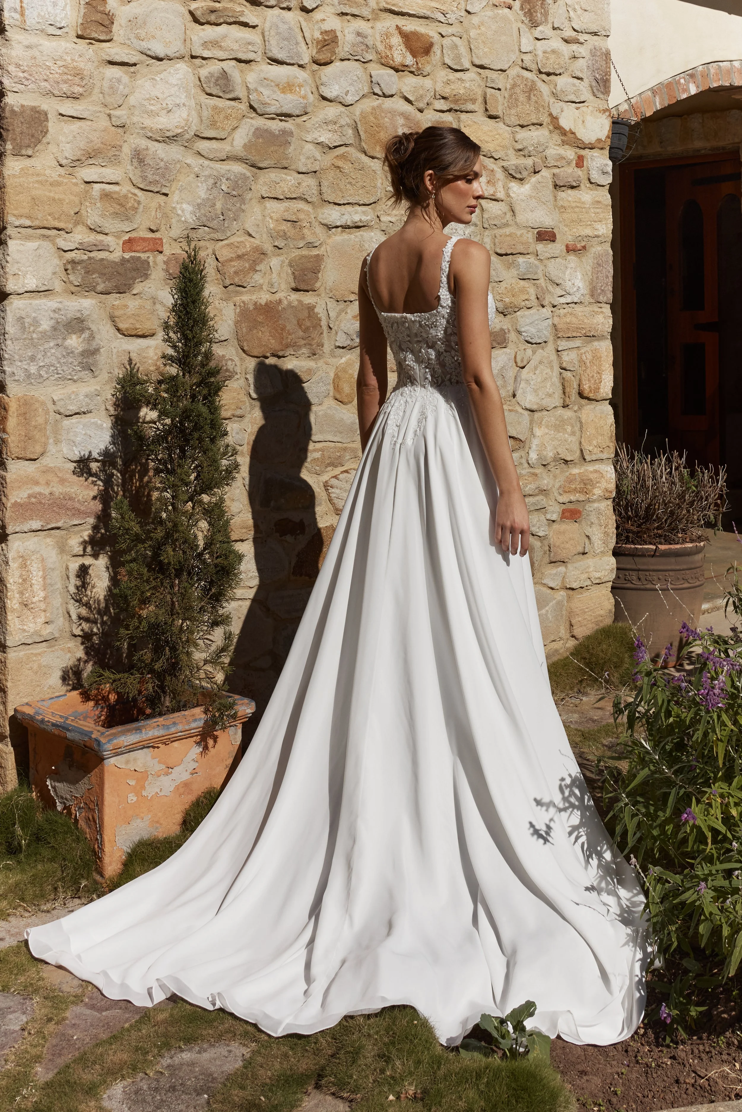 Zinnia Back view of gown A-line wedding dress in soft georgette with square neckline, lace appliqué bodice and flowing chapel train
