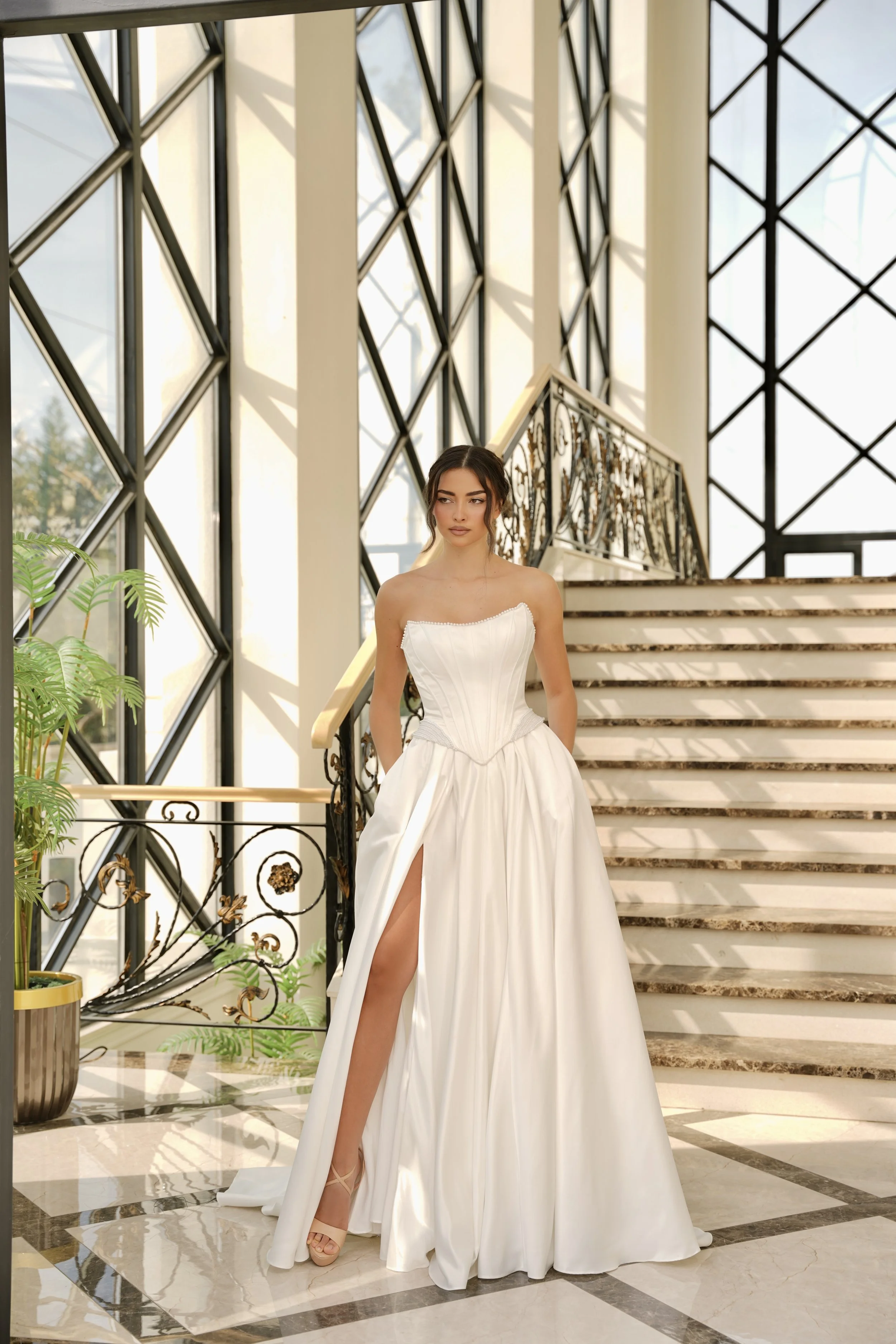 Delicate pearl detailing traces the neckline, adding a soft, romantic finish.