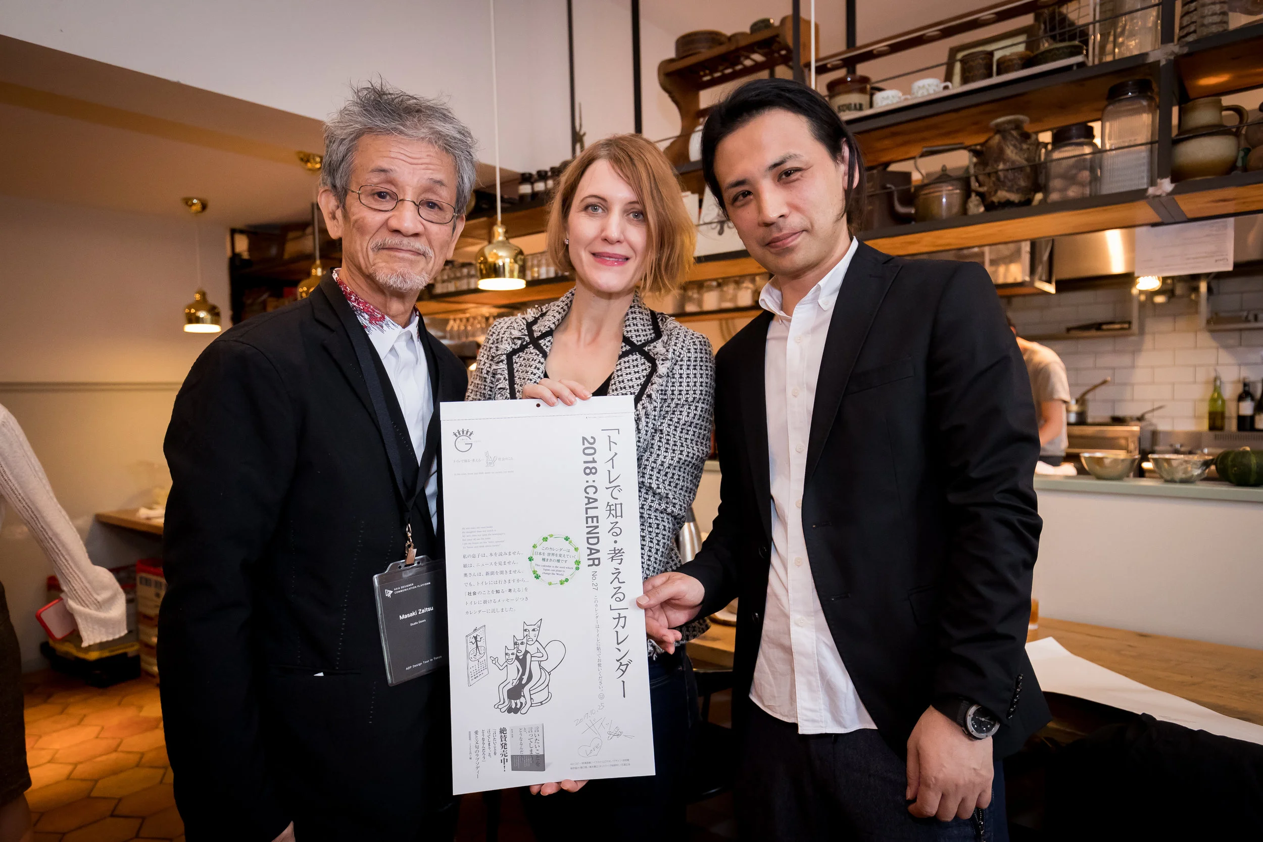 Japanese Prestigious Graphic Designer Mr. Masaki Zaitsu and the Calendar He Designed with ADP Regional President Annie Ivanova and ADP Japanese Member Representative Hajime Tsuruta (Left to Right) .jpg