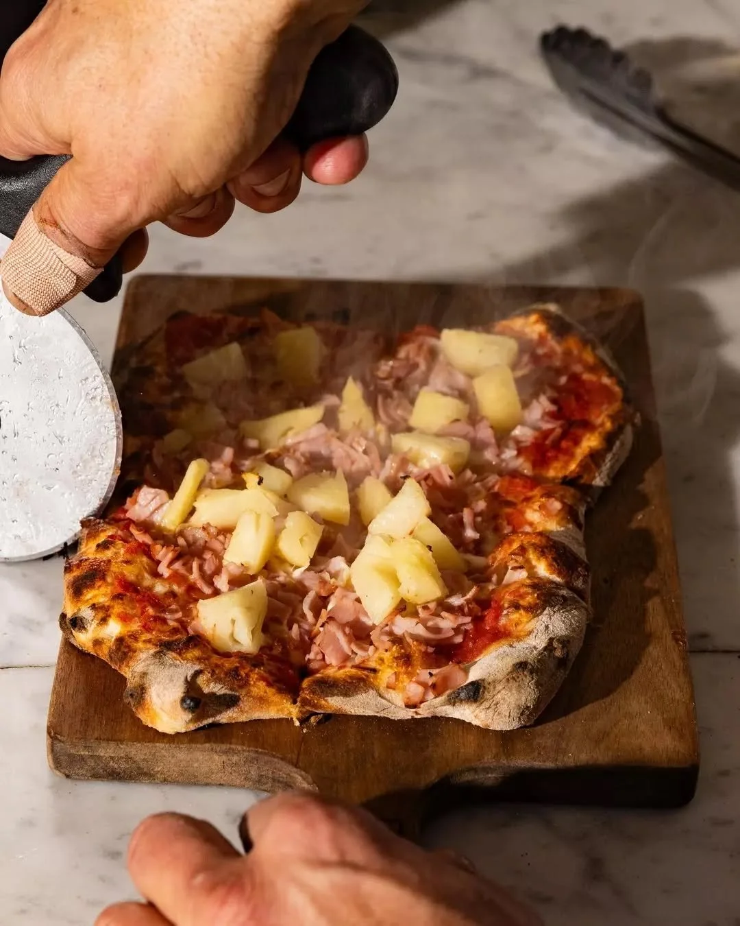 The Violation, because pineapple on pizza will always spark debate.&nbsp;
Smoked leg ham, molten mozzarella, sweet pineapple, and our signature Roman base with just the right crunch.